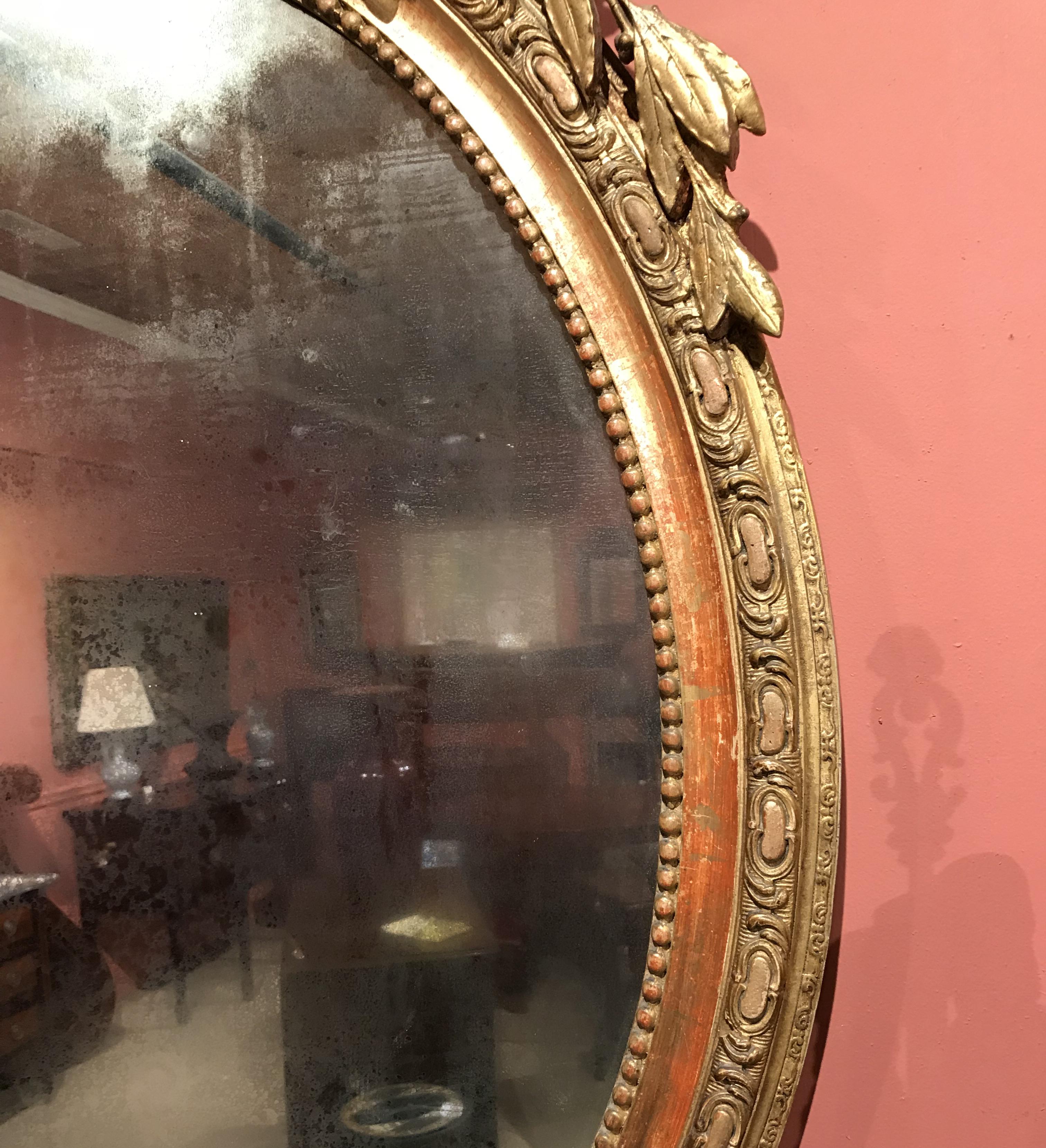 French Gilt Foliate Decorated Oval Wall Mirror, Early 19th Century In Good Condition In Milford, NH