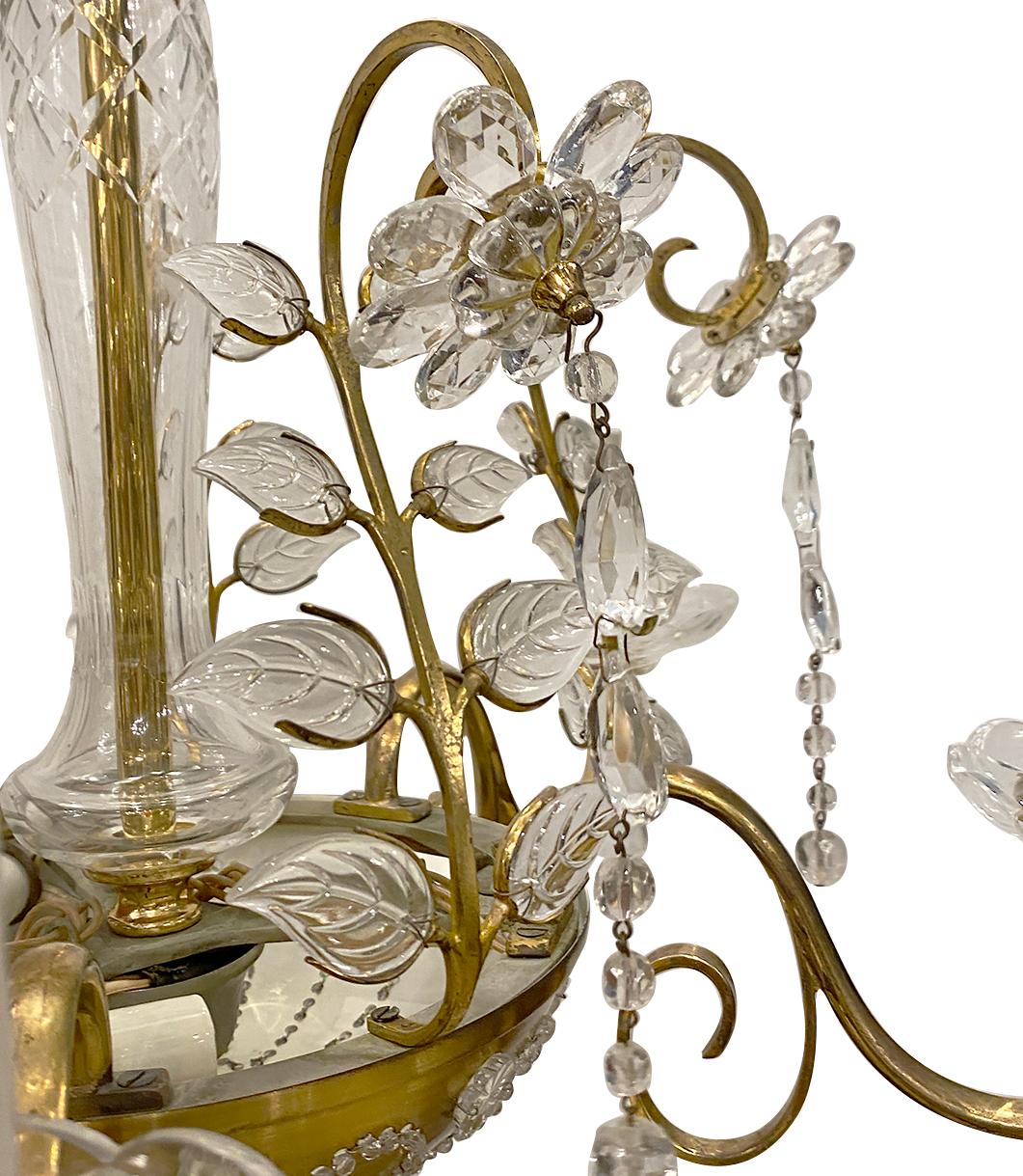 A circa 1920s French gilt metal chandelier with molded glass leaves and crystal flowers.

Measurements:
Minimum drop: 25