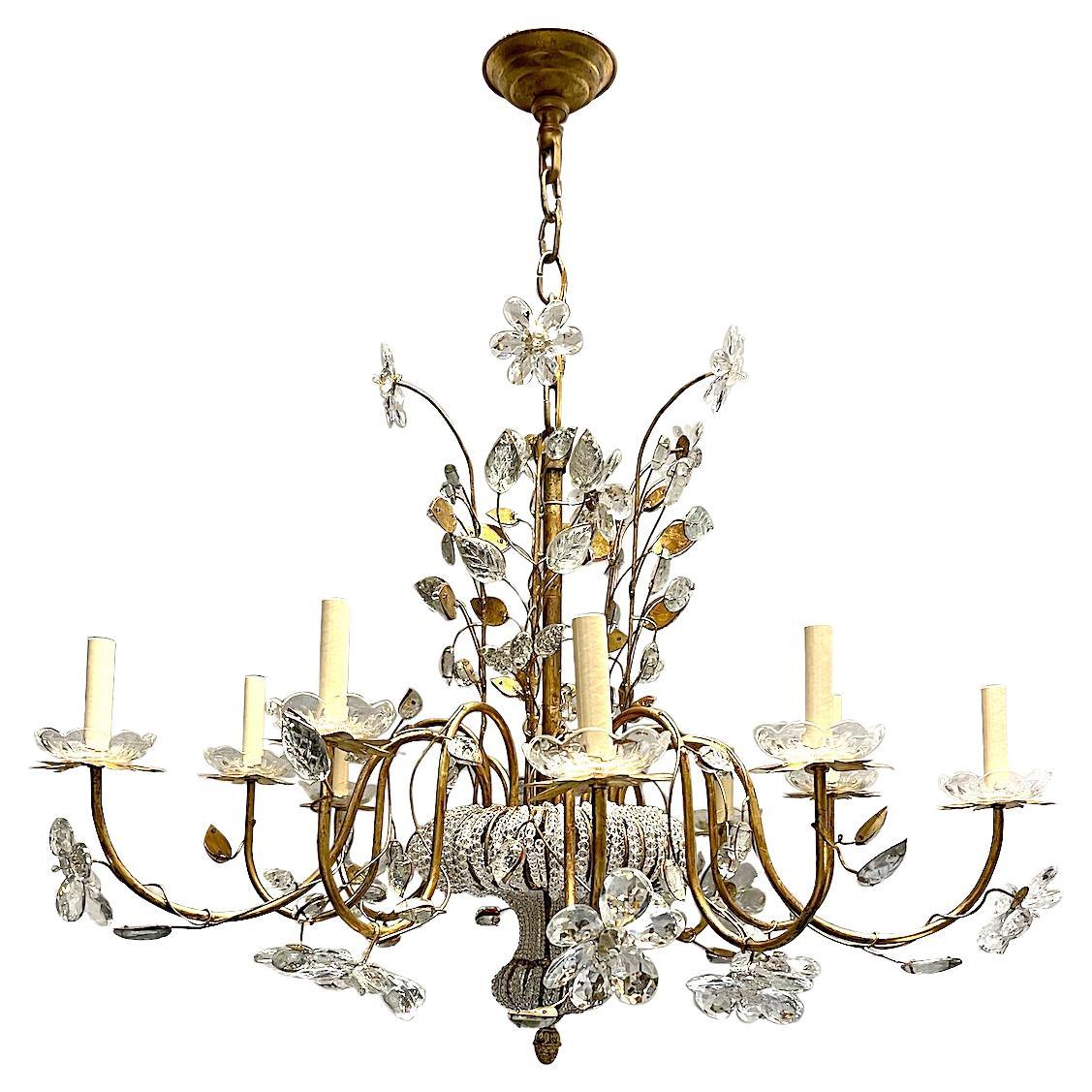 A circa 1950's French gilt chandelier with beaded body and crystal flowers. 10 lights.

Measurements:
Drop: 32