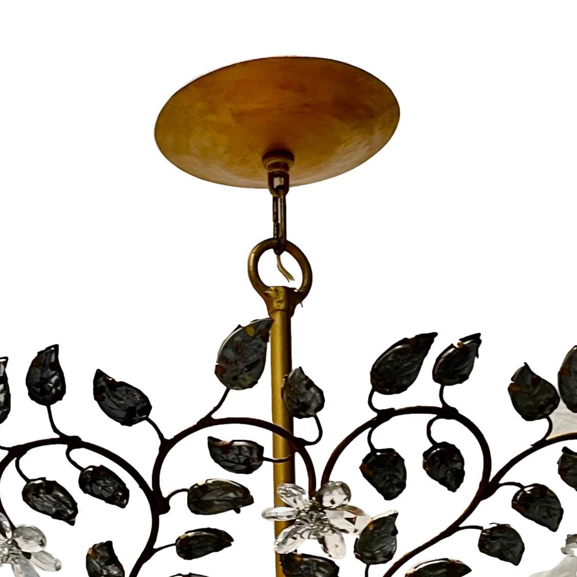 A circa 1960's French gilt light fixture with molded glass leaves on body and eight interior candelabra lights.

Measurements:
Drop: 24