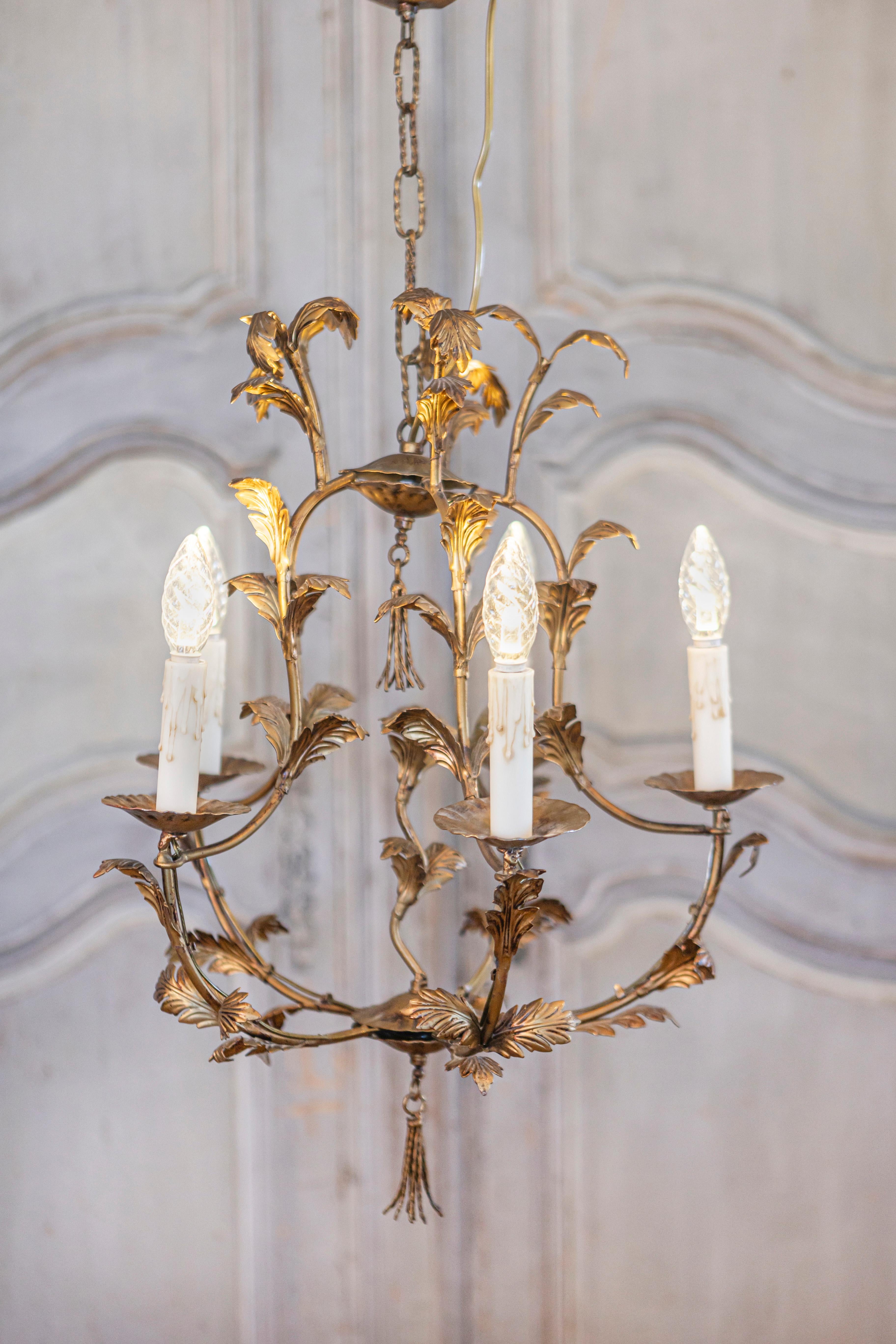 A French gilt metal five-light chandelier from the 20th century inspired by Maison Charles. This elegant French gilt metal five-light chandelier from the 20th century, inspired by the prestigious Maison Charles, exhibits an exquisite design with its
