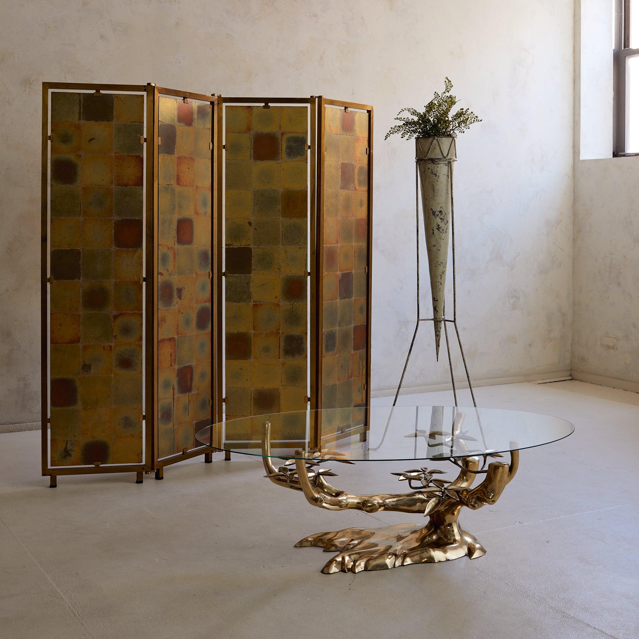 A four-panel screen that offers two moods in one piece: golden mosaic on one side, inky velvet on the other.

Hand-gilt metal frames hold square tiles of gold leaf that have mellowed into warm notes of saffron, russet, and olive—a natural patina