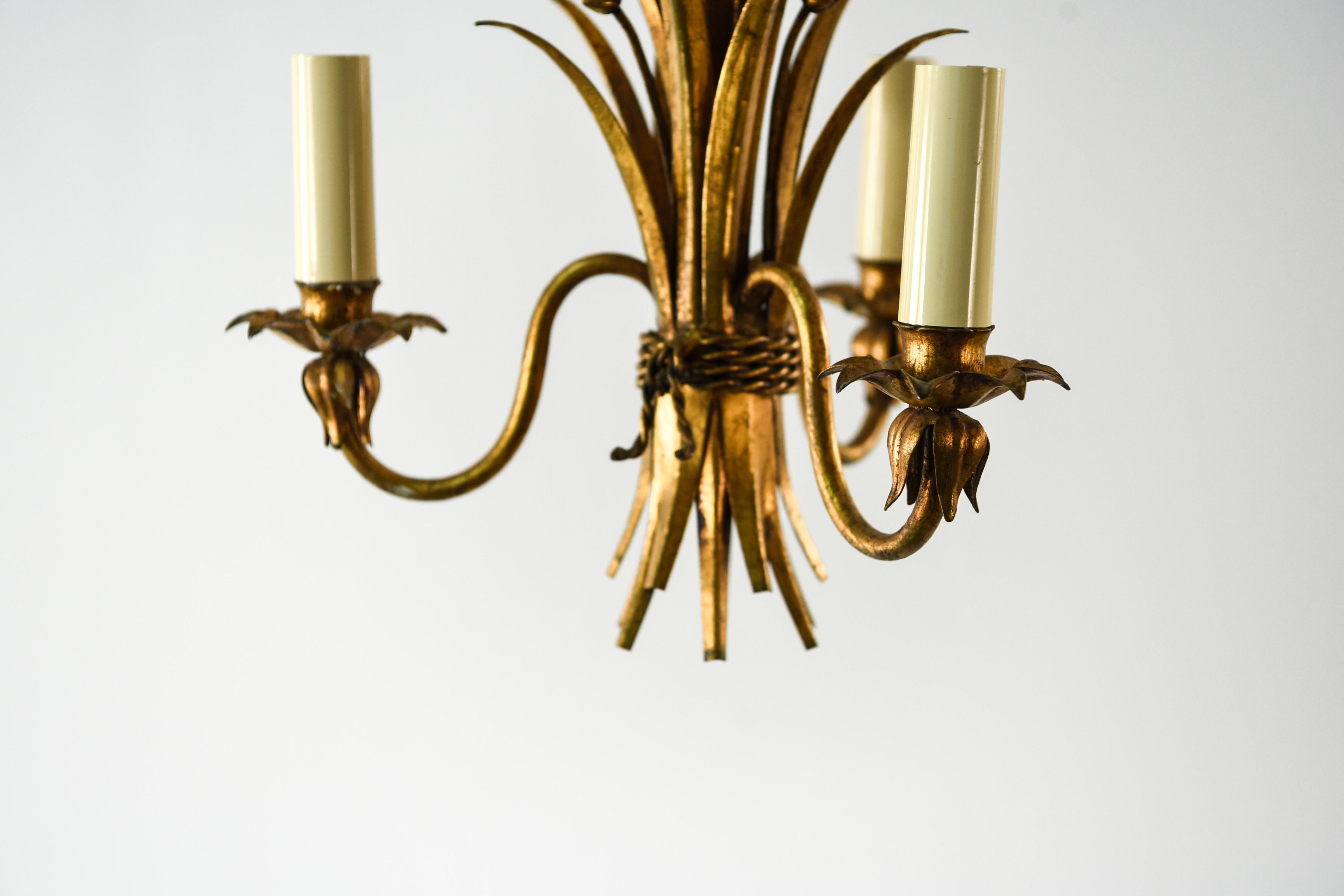 This French 3-arm chandelier is in a timeless sheaf of wheat form, popularly produced during the Hollywood Regency period. This piece incorporates the classic well-loved style into a modern production.