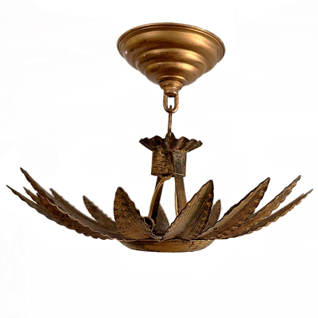 A circa 1950's gilt metal pendant sunburst light fixture with two interior lights.

Measurements:
Diameter: 14