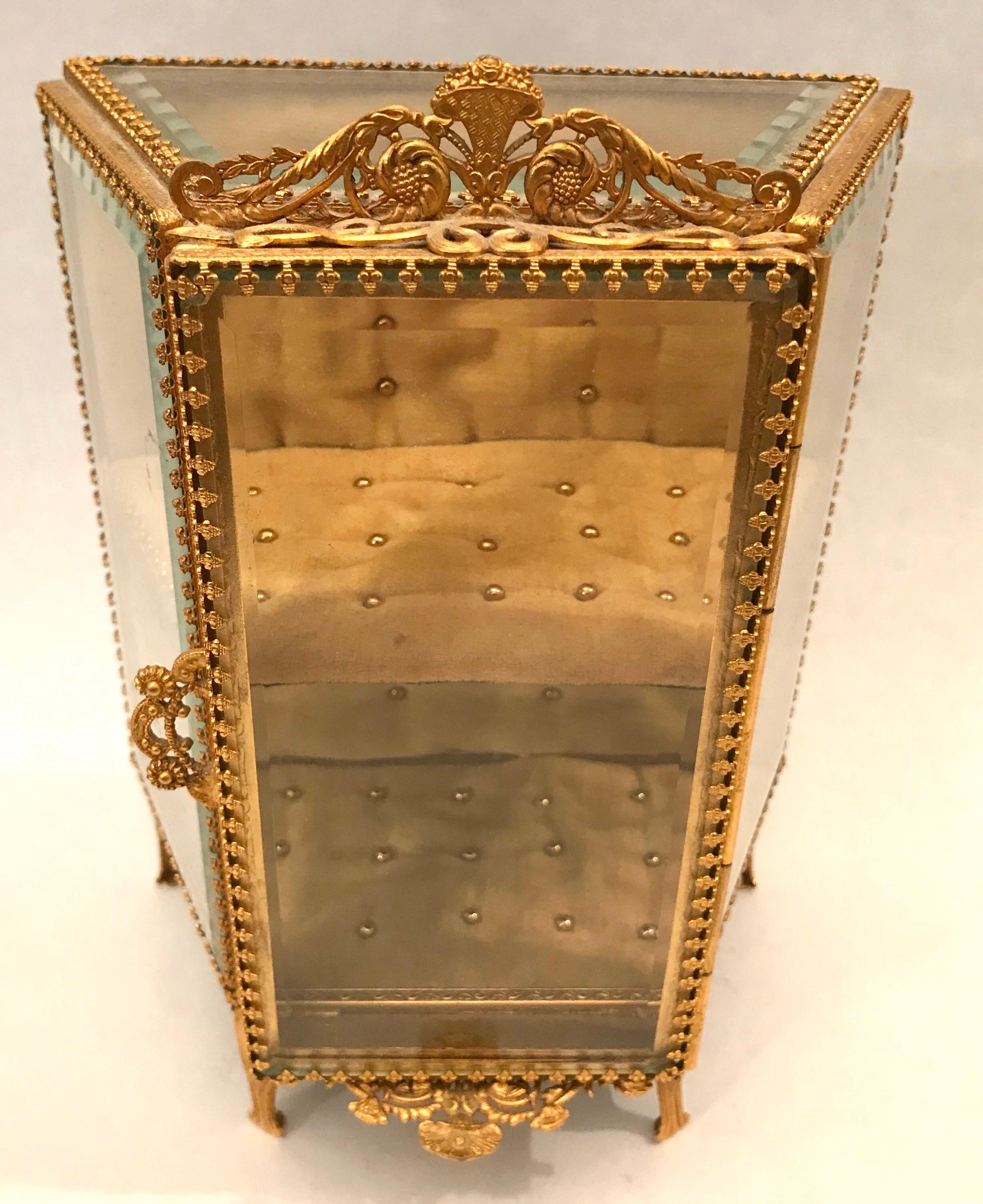 Gilt ormolu and beveled glass jewelry box or display in the form of a miniature vitrine.