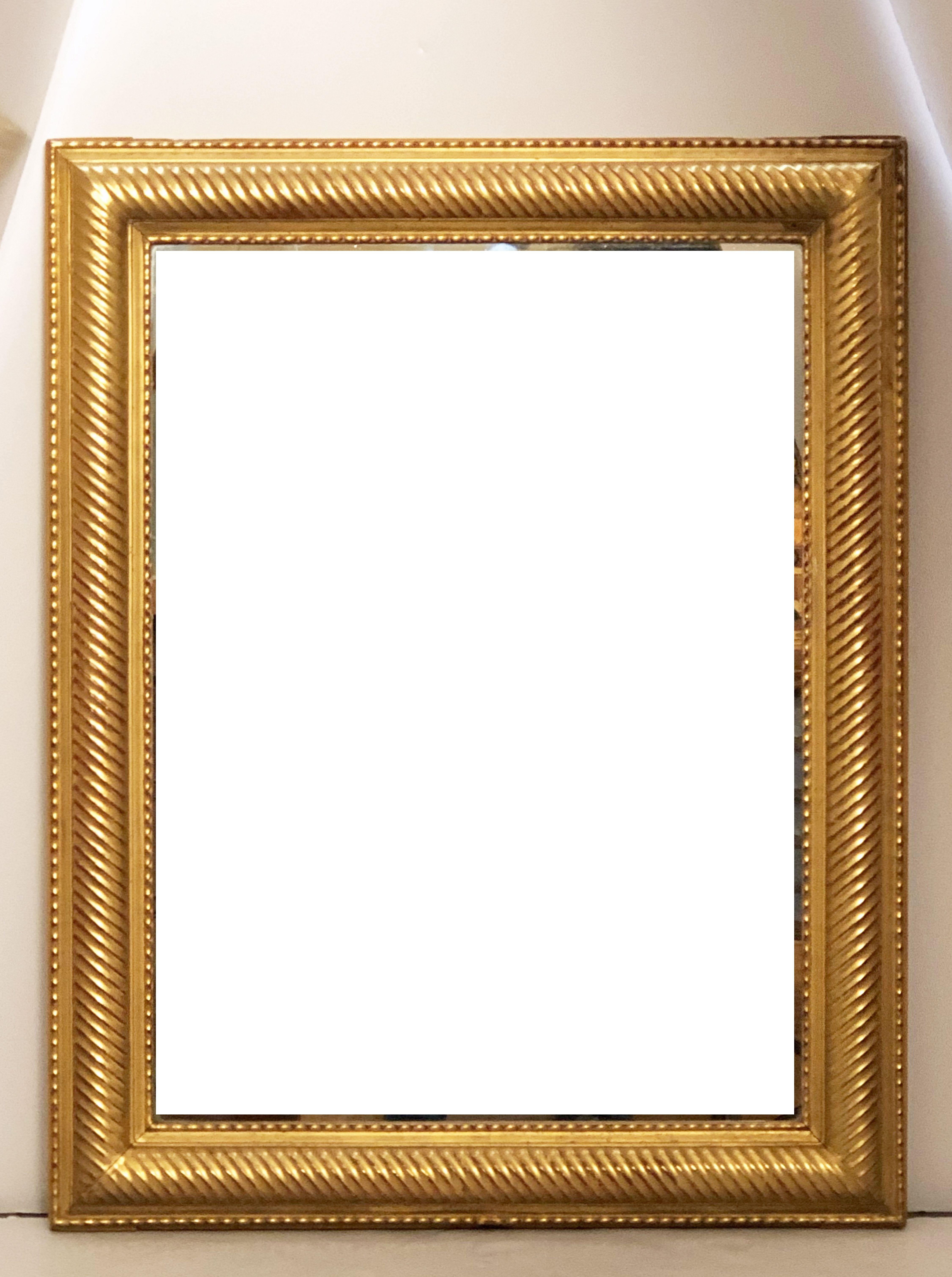 A handsome French gilt rectangular wall mirror featuring a raised, ribbed edge around the circumference and a lovely warm gold-leaf patina.

Ready to hang - Can be displayed vertically or horizontally

Dimensions: H 39 inches x W 30 3/4 inches x