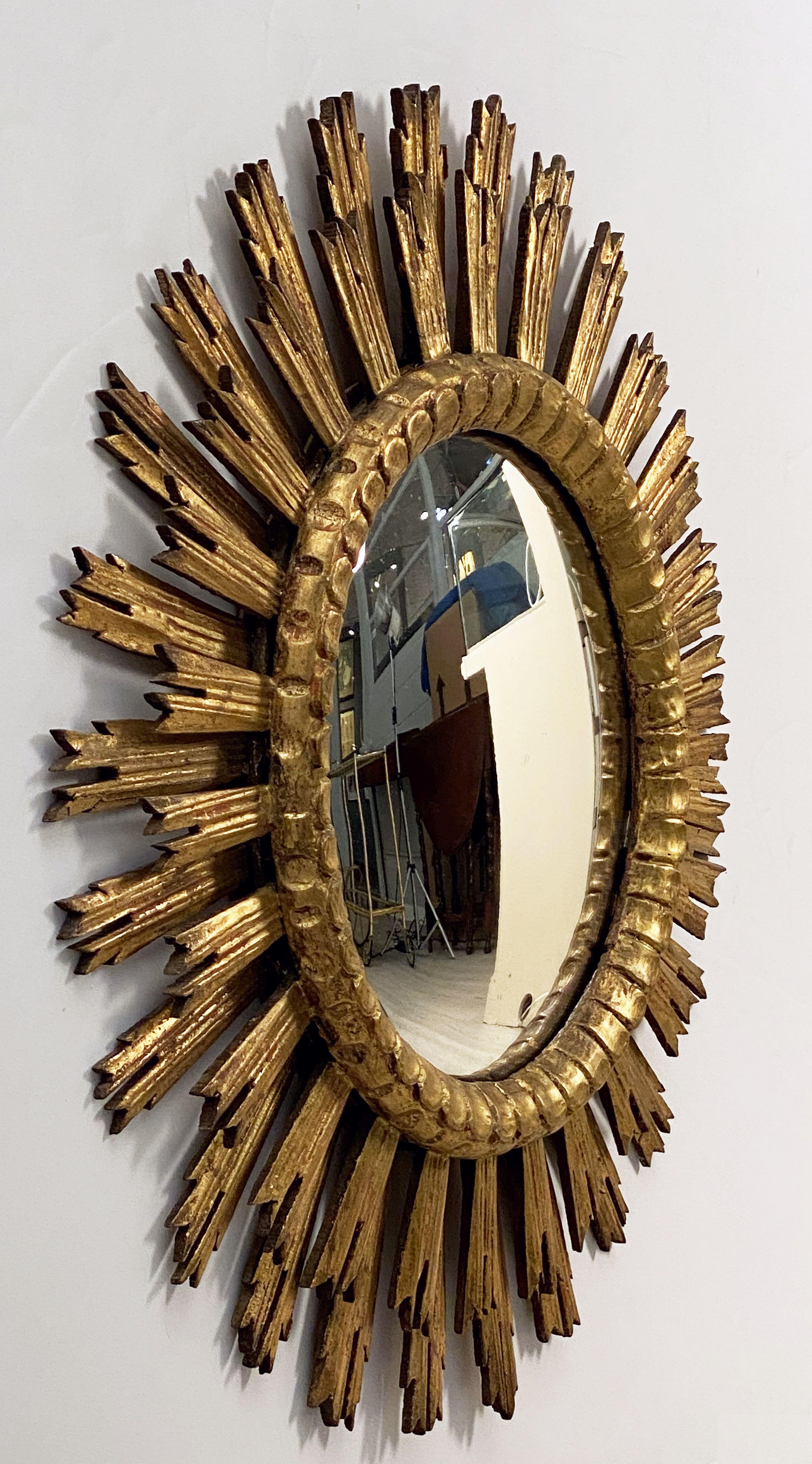 A lovely French gilt sunburst (or starburst) mirror, 30 inches diameter, with a round, convex mirrored glass centre in moulded frame.
