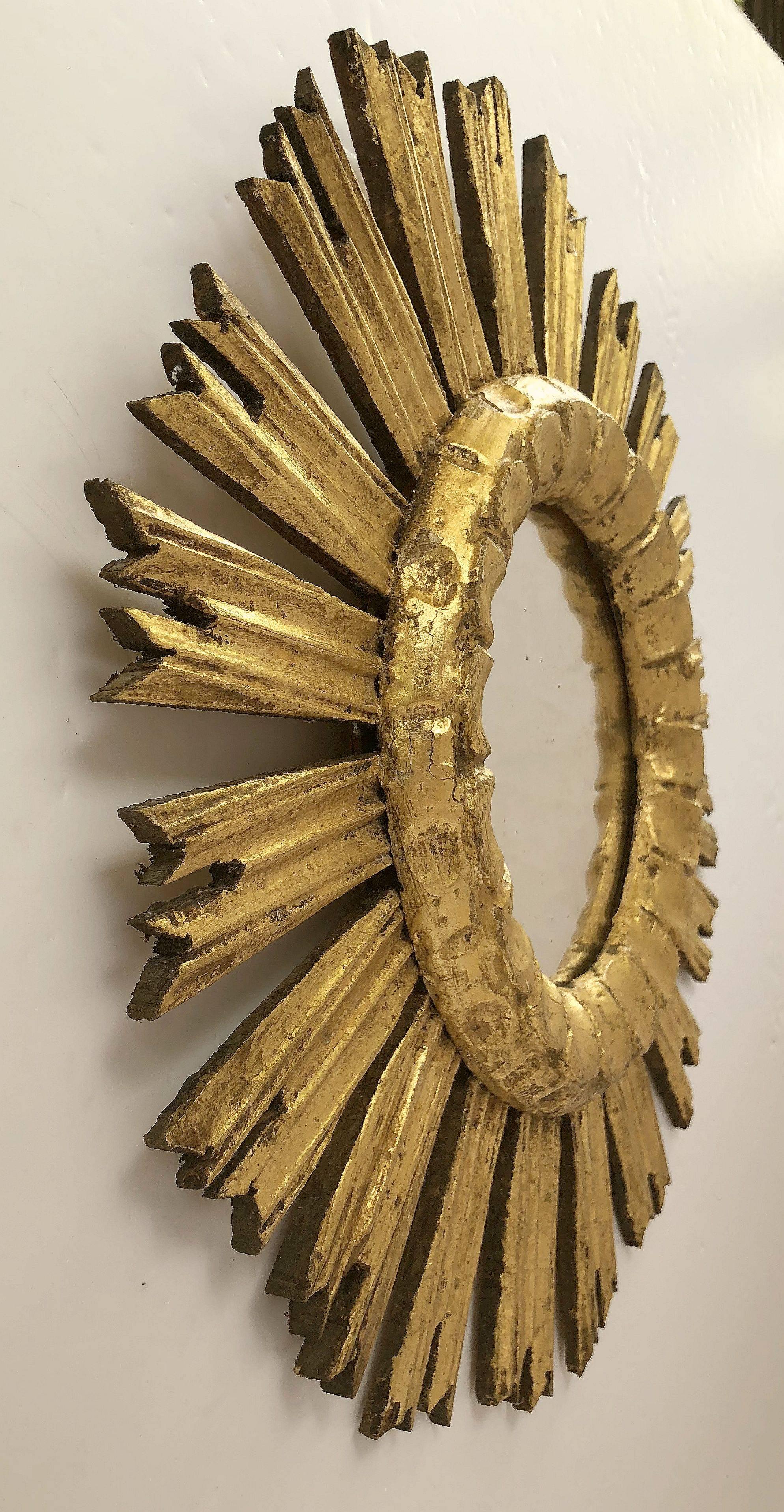 A lovely French gilt sunburst (or starburst) mirror, 16 inches diameter with round mirrored glass centre in moulded frame.