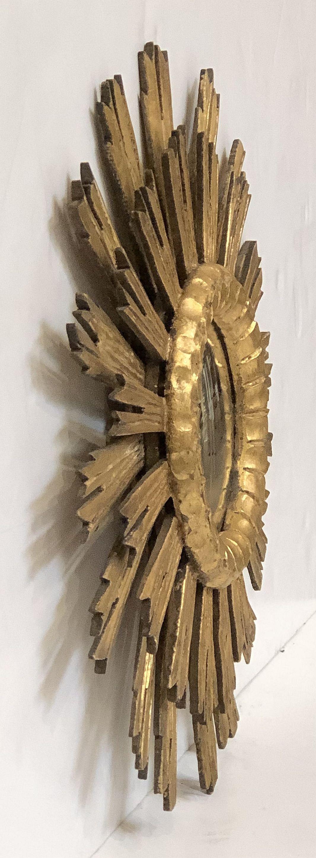 A lovely French gilt sunburst (or starburst) mirror, 21 inches diameter with round mirrored glass center in a moulded frame.