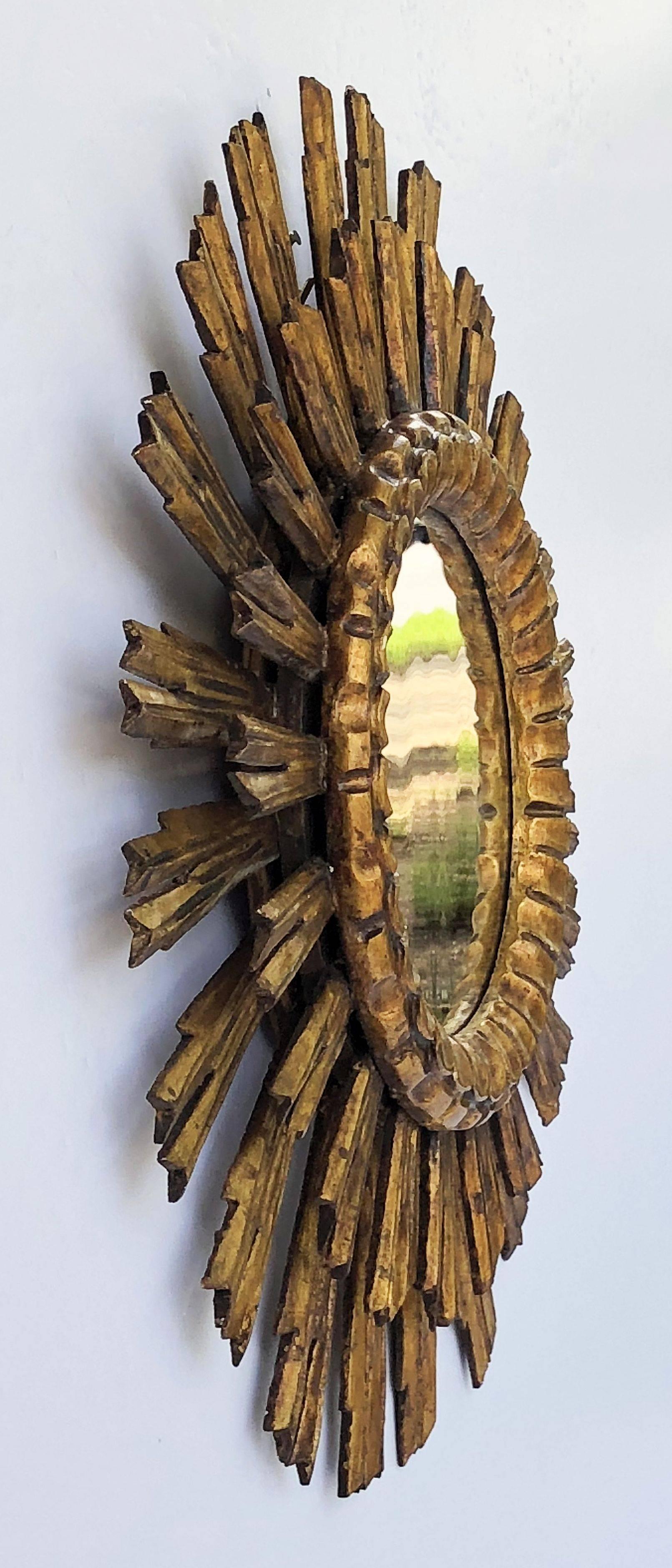 A lovely French gilt sunburst (or starburst) mirror, 24 inches diameter, with round mirrored glass centre in moulded frame.