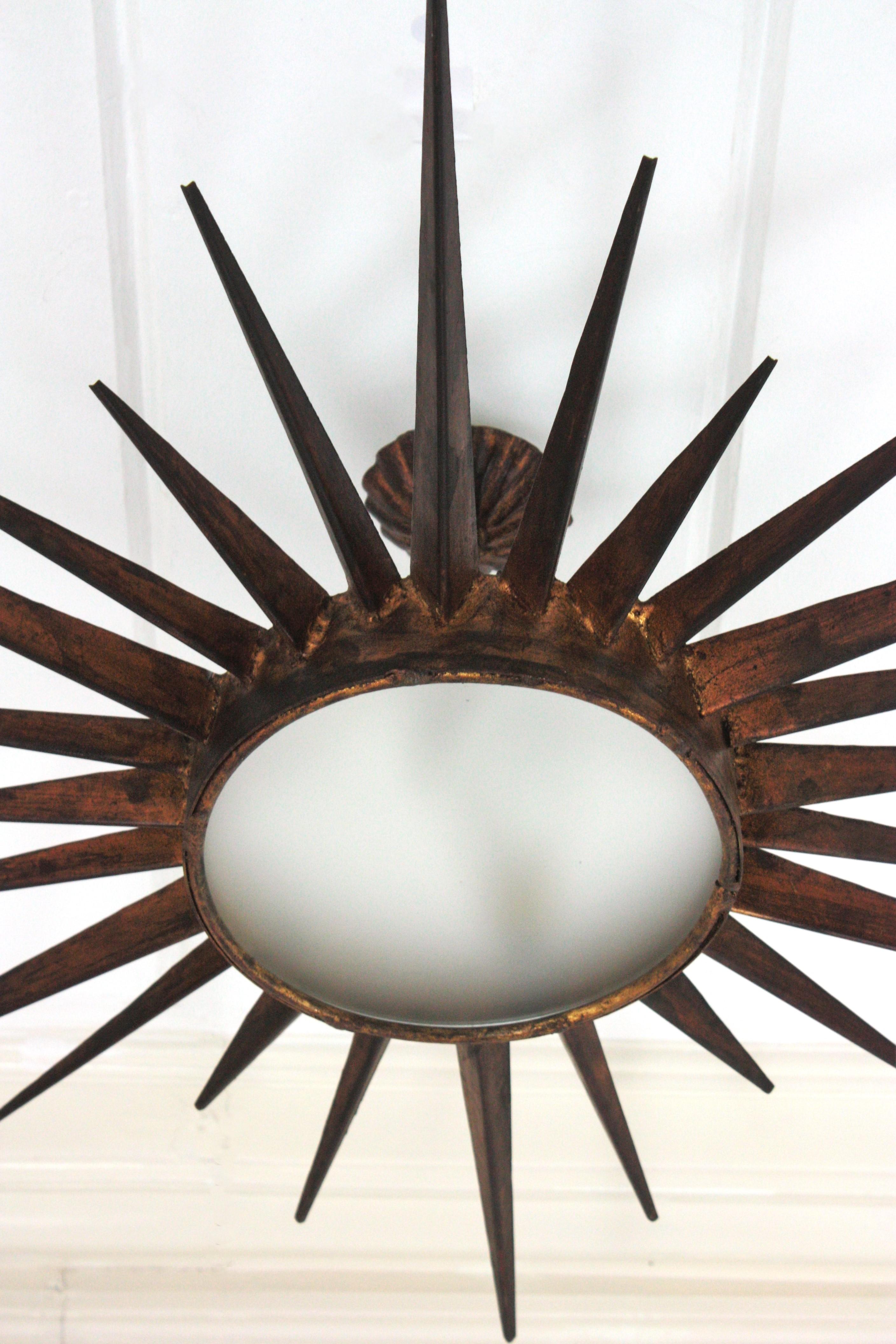 Forged French Gilt Starburst Sunburst Light Fixture in Wrought Iron, Poillerat Style For Sale