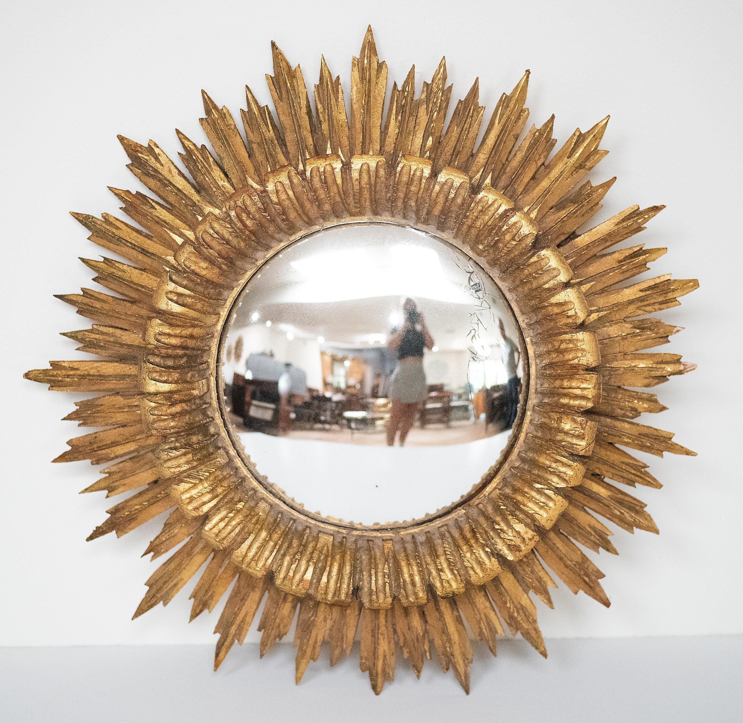 A lovely French gilt sunburst (or starburst) convex mirror with beautifully gilded wooden rays arranged around the mirror plate glass center.  

Diameter 16 1/2 inches