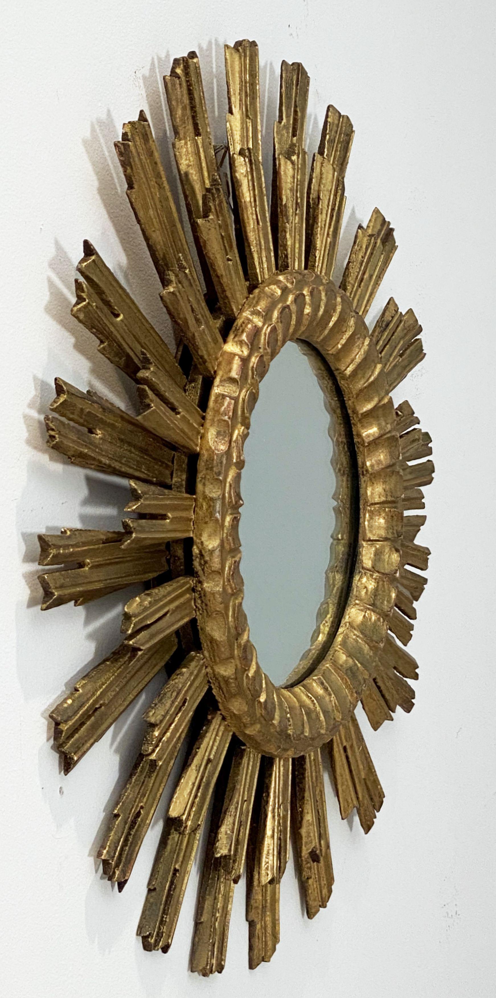 A lovely French gilt sunburst (or starburst) mirror with a double row of gilded wooden rays arranged around the original glass mirror plate glass center.

Measures: Diameter of 24 1/2 inches

 