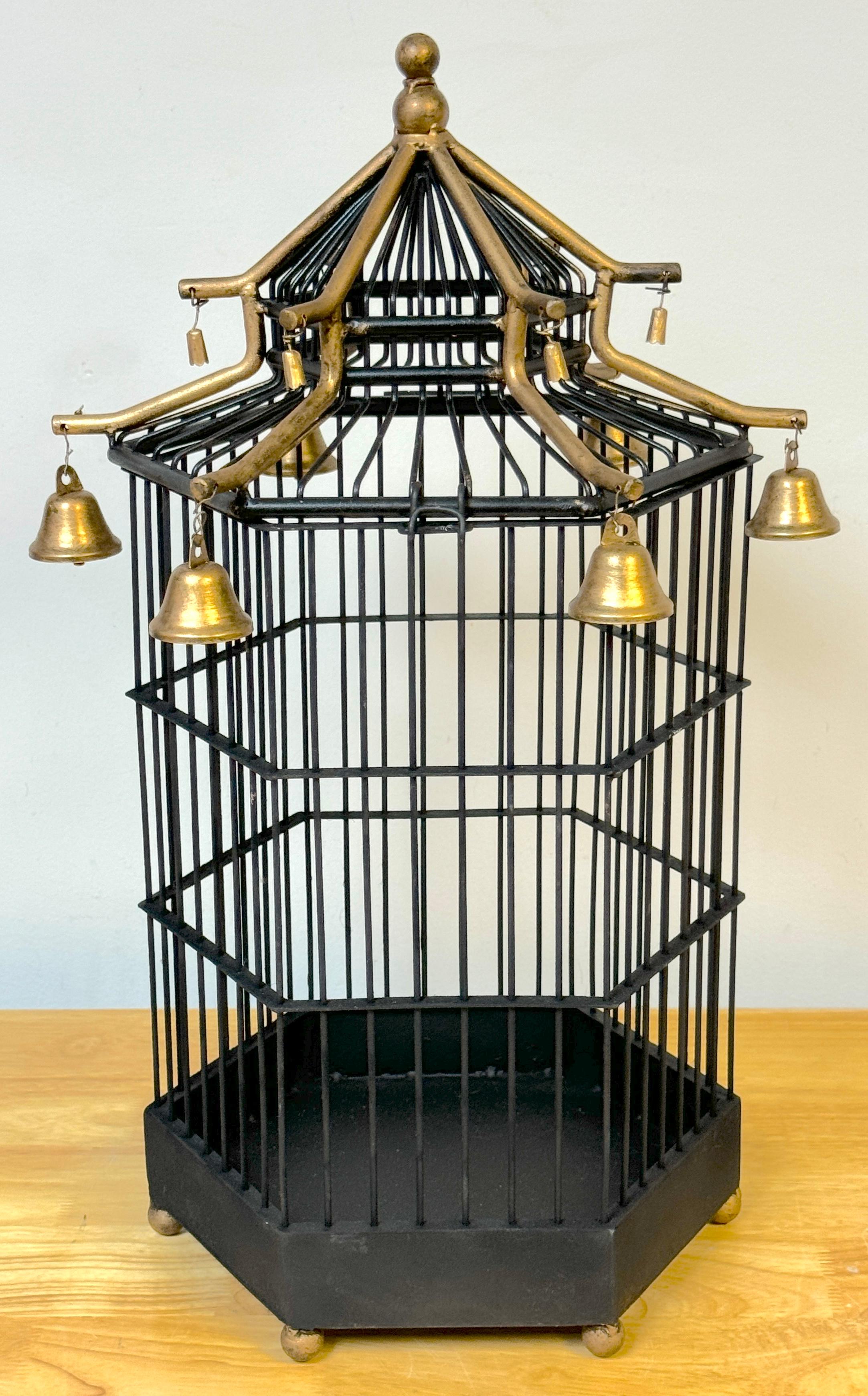 French Gilt Tole Hexagonal Pagoda Birdcage with Bells 
France, 1900s

This exquisite French gilt-tone hexagonal pagoda birdcage, dating from the early 1900s, is a beautifully made and functional decorative work. Standing 20 inches high with an upper