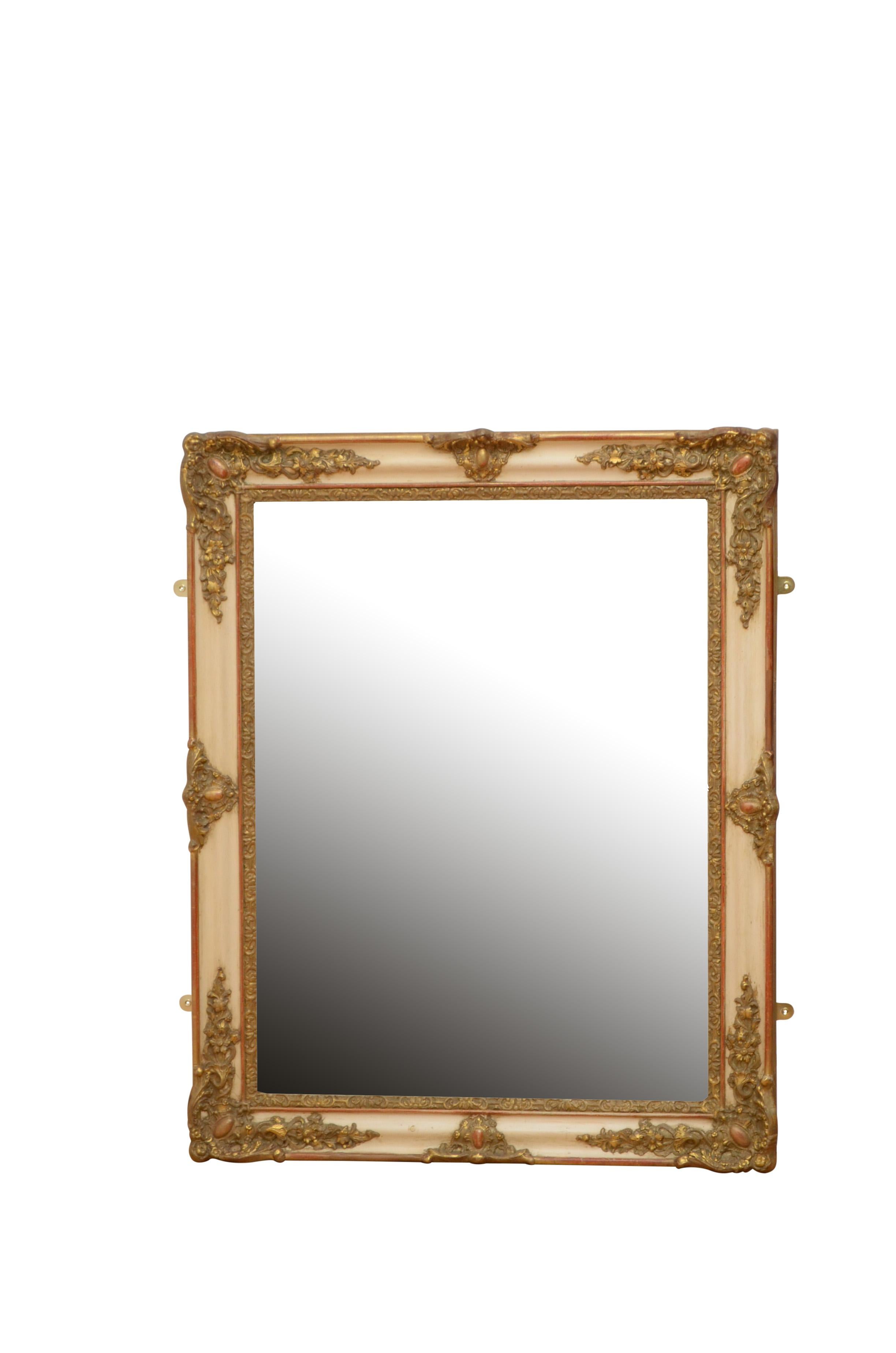 K0461 19th century wall mirror of versatile form could be positioned portrait or landscape, having original mirror plate with superb foxing in beautifully carved and gilded frame with decorative flora motifs to corners. This antique gilt mirror