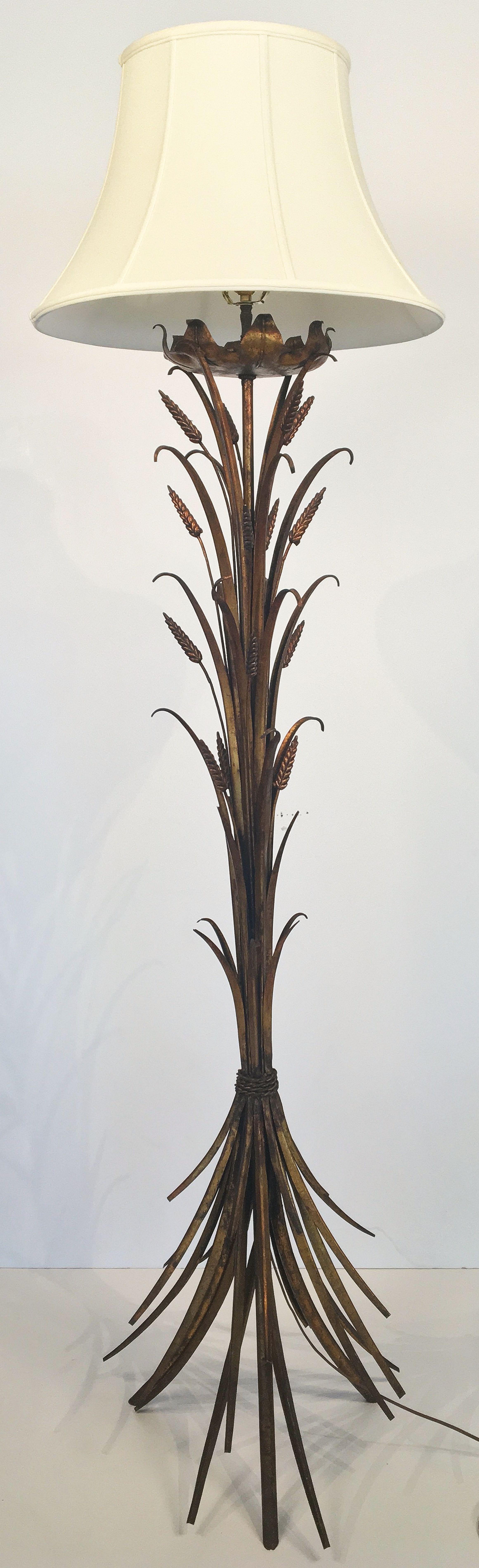 A stylish French floor lamp of gilt metal, with shade, featuring the wheat sheaf (or wheatsheaf) design made famous by Coco Chanel.