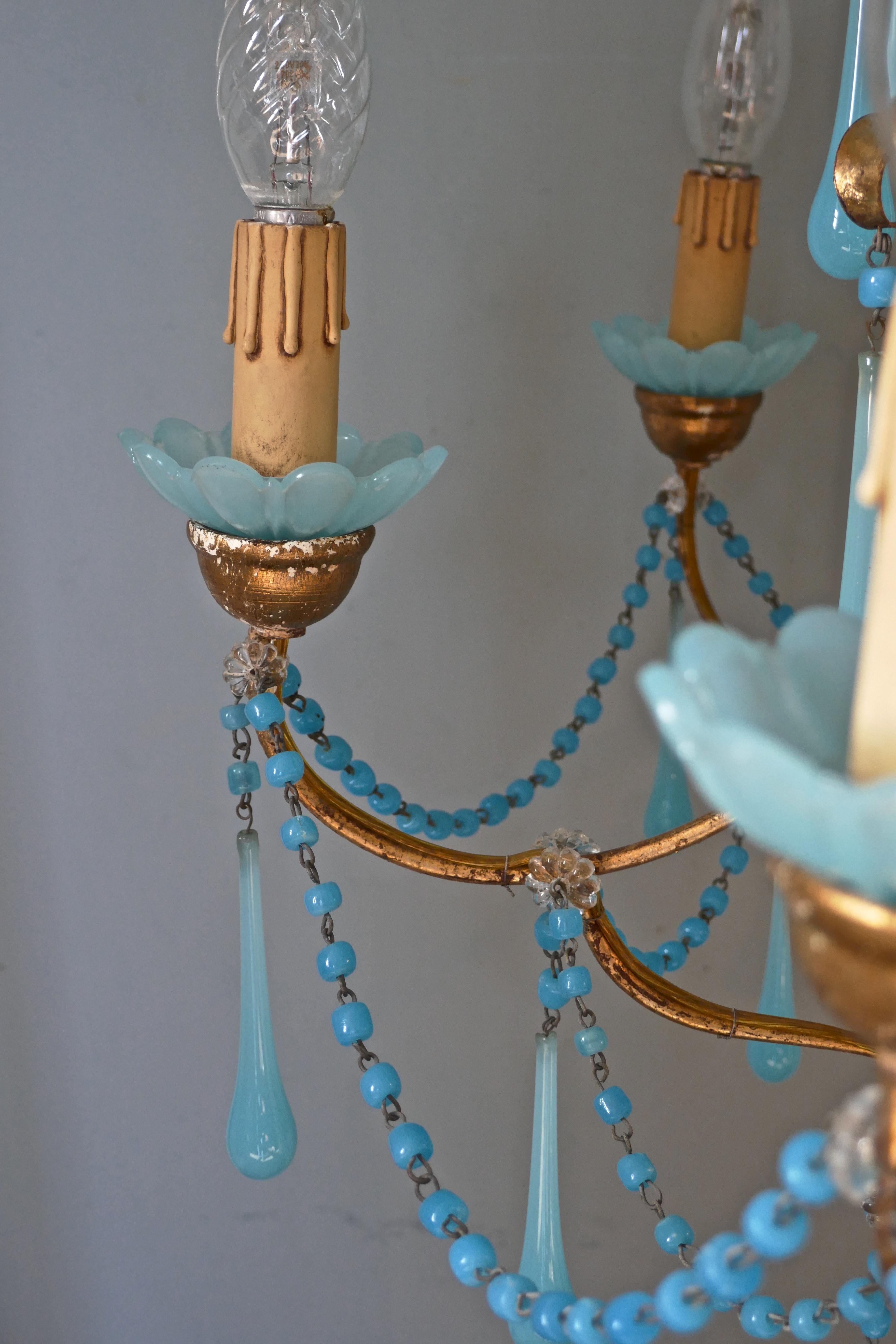 French giltwood and toleware Turquoise opaline glass 6 branch chandelier.

This is an excellent quality and very dainty piece, the wood and toleware has a gilded finish, the 6 arms have turquoise glass sconces
The light is hung with beautifully