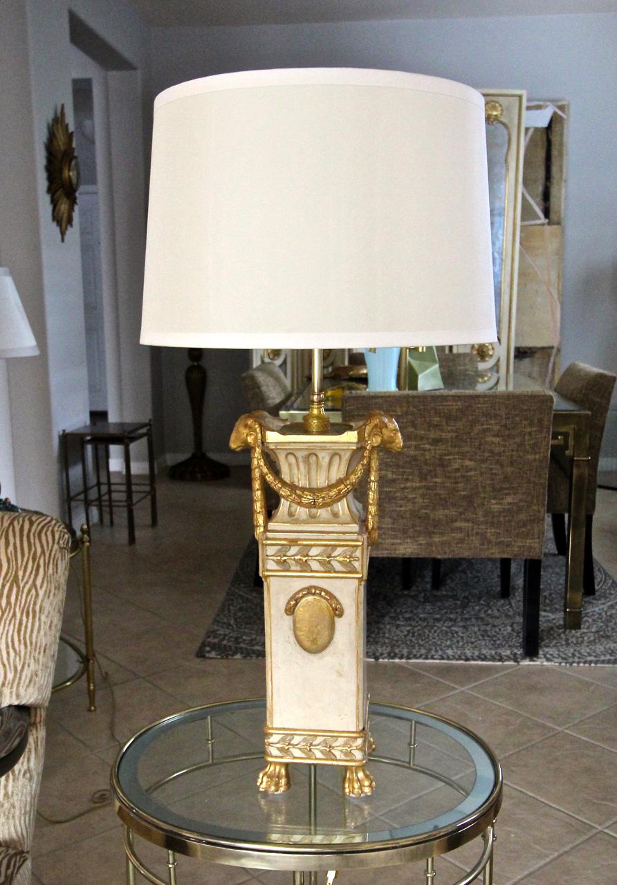 French Directoire 19th century carved 23k water gilt finish and partial painted wood table lamp. Expertly crafted including rams head, paw feet and and swags motif. Includes antiqued finish brass fittings with 2 pull chain sockets, newer wiring.