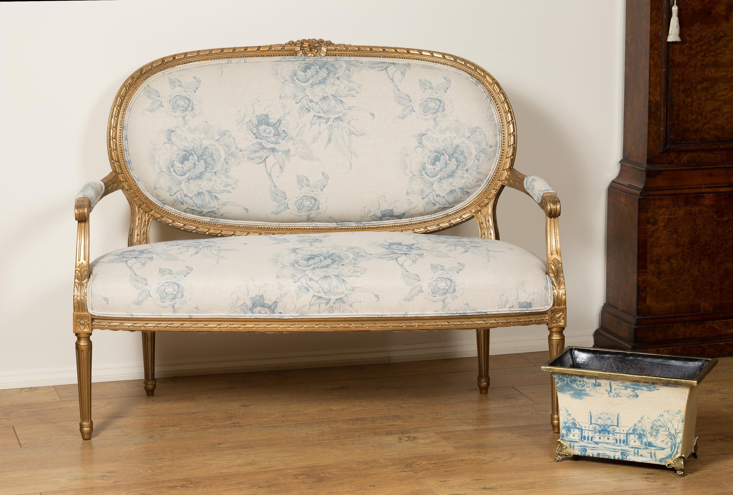 French gilt wood two seat settee standing on tapered fluted legs with beautifully carved decoration, c.1870.