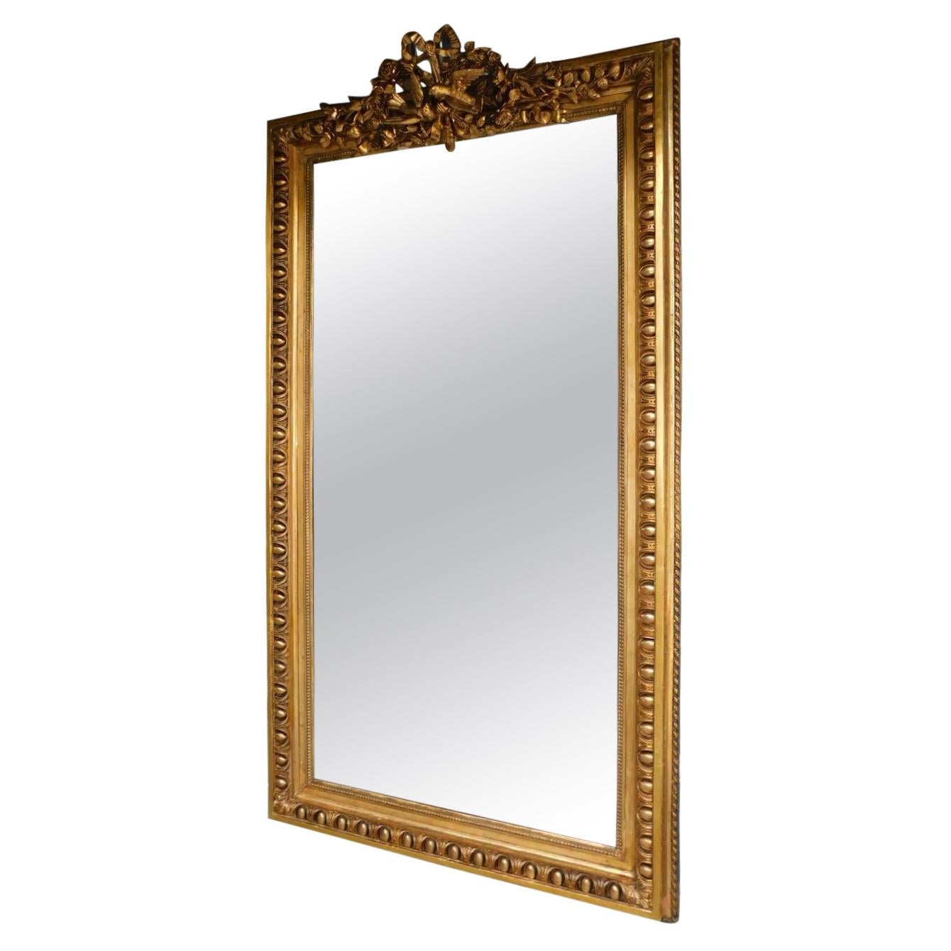 French Gilt Wood Wall Mirror with Dove's Ribbon and Foliage Cartouche Circa 1820 For Sale