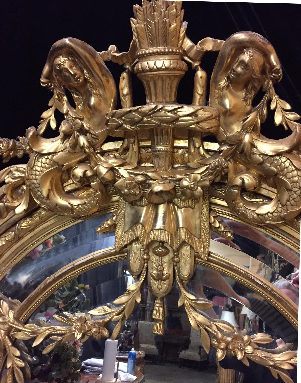Spectacular 19th century French Louis XVI style carved giltwood and gesso figural mirror. 

The beautiful mirror is surmounted by a gilt quiver containing a multitude of arrows flanked by two finely carved mermaids over drapery and tassels. The