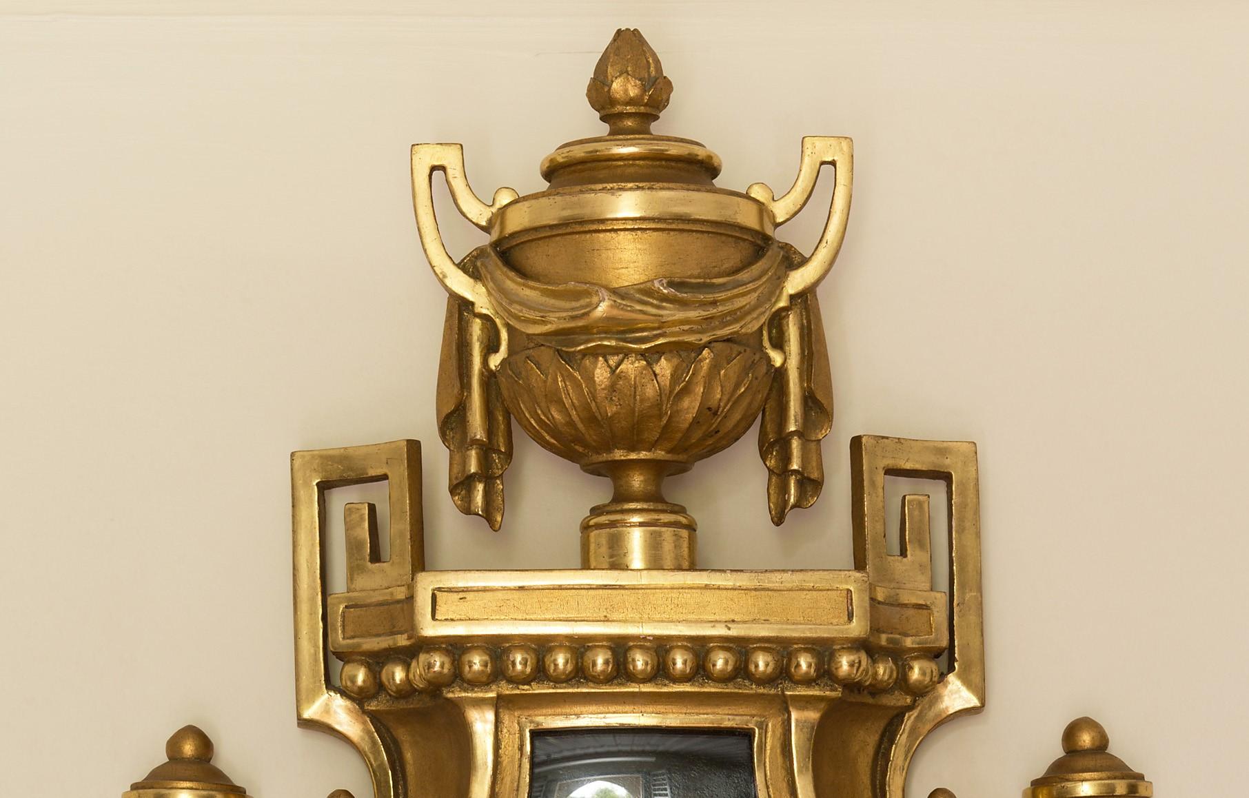 Gilt French cartel clock

Enamel dial with Roman numerals signed Defaud, Paris.

Giltwood case with swag decoration and visible pendulum.

Eight day movement striking the hours and halves on a silvered bell. The backplate stamped C.H.Paris