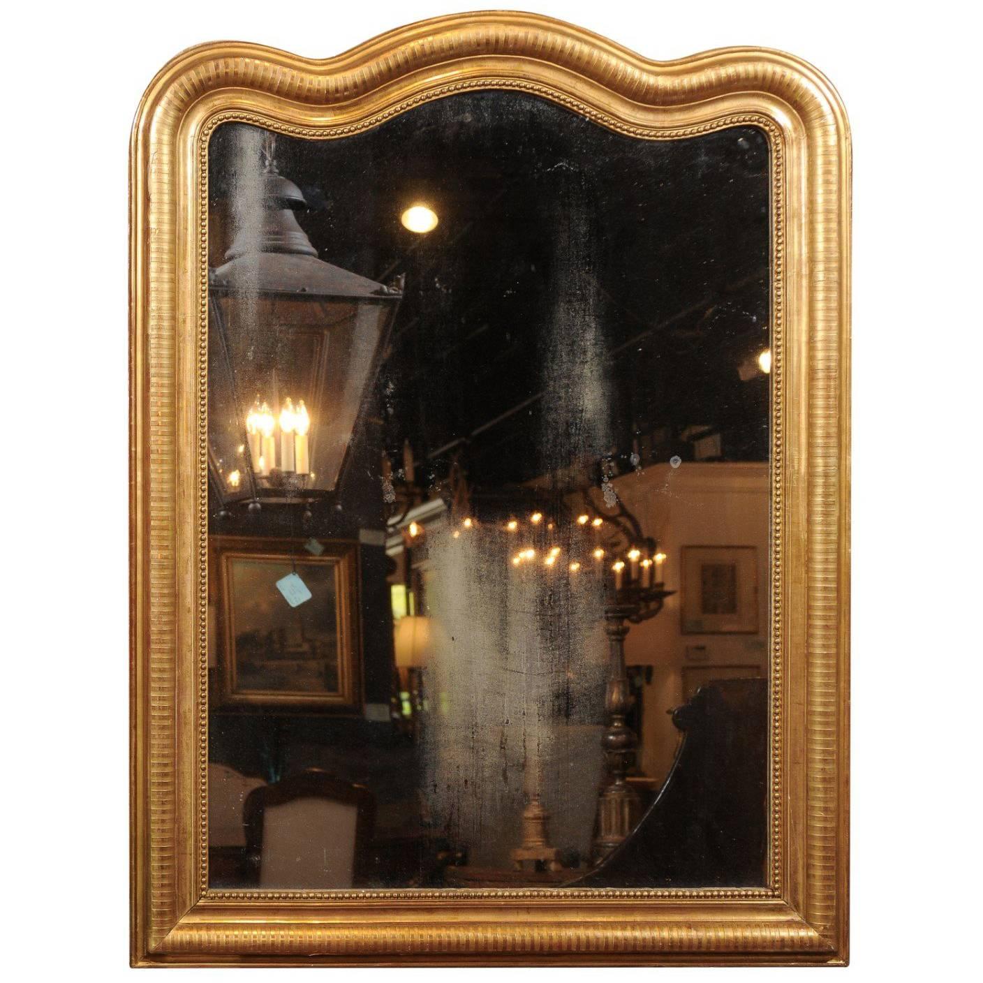 French Giltwood Louis-Philippe Mirror with Sinuous Top from the 19th Century For Sale