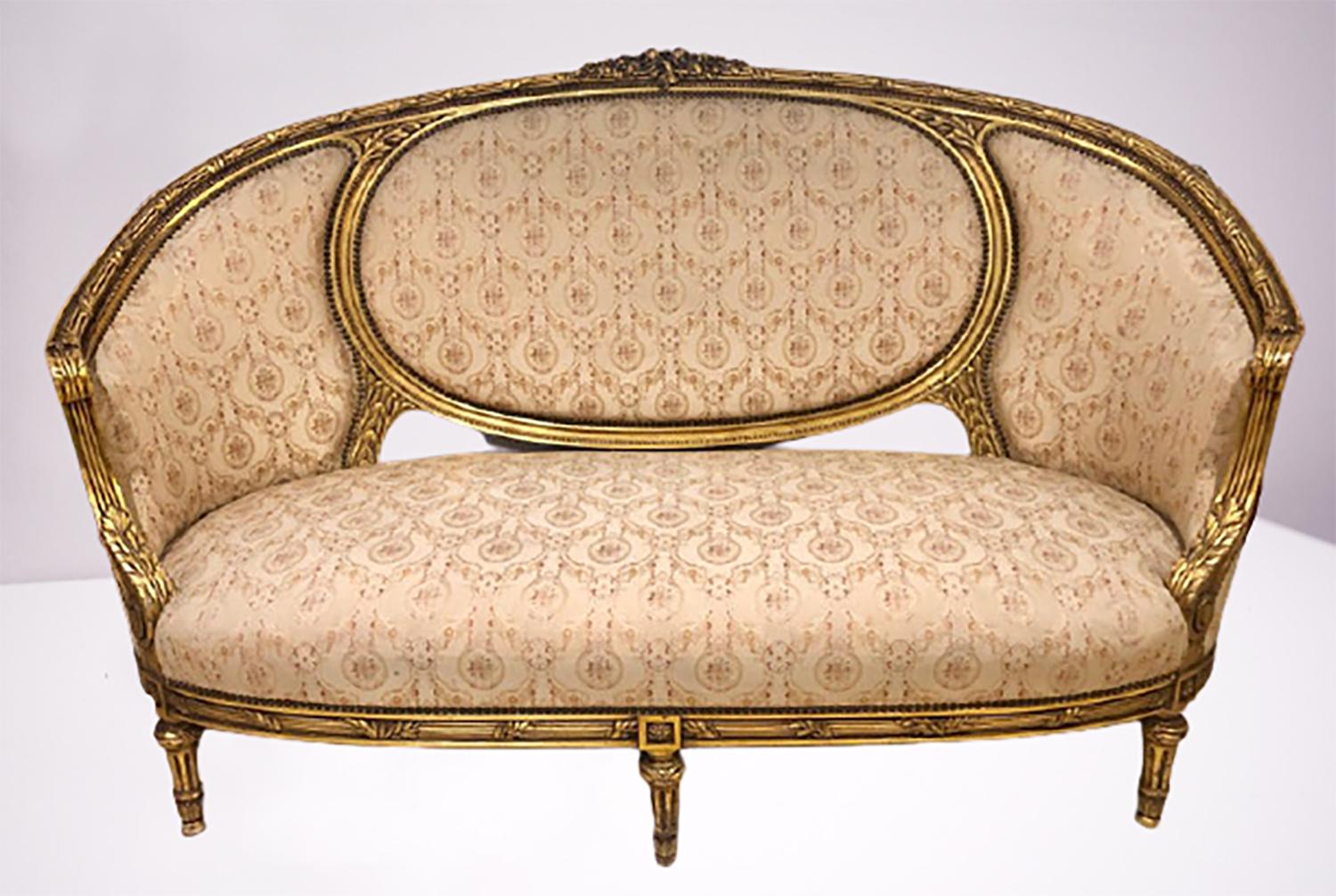 French giltwood Louis XVI style Cameo back sofa settee and pair armchairs. This is a large and impressive living room setting in a very lovely French inspired upholstery. The sleek and fine frames in a full gilt gold finish having carved leaf and