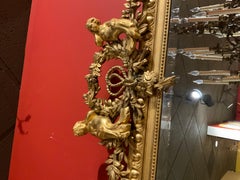 French Giltwood Mirror with Floral Garlands, Bows, Putti and Egg and Dart Frame