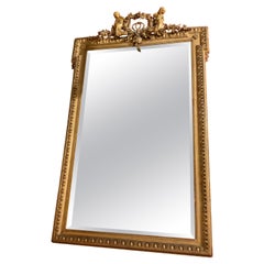French Giltwood Mirror with Floral Garlands, Bows, Putti and Egg and Dart Frame