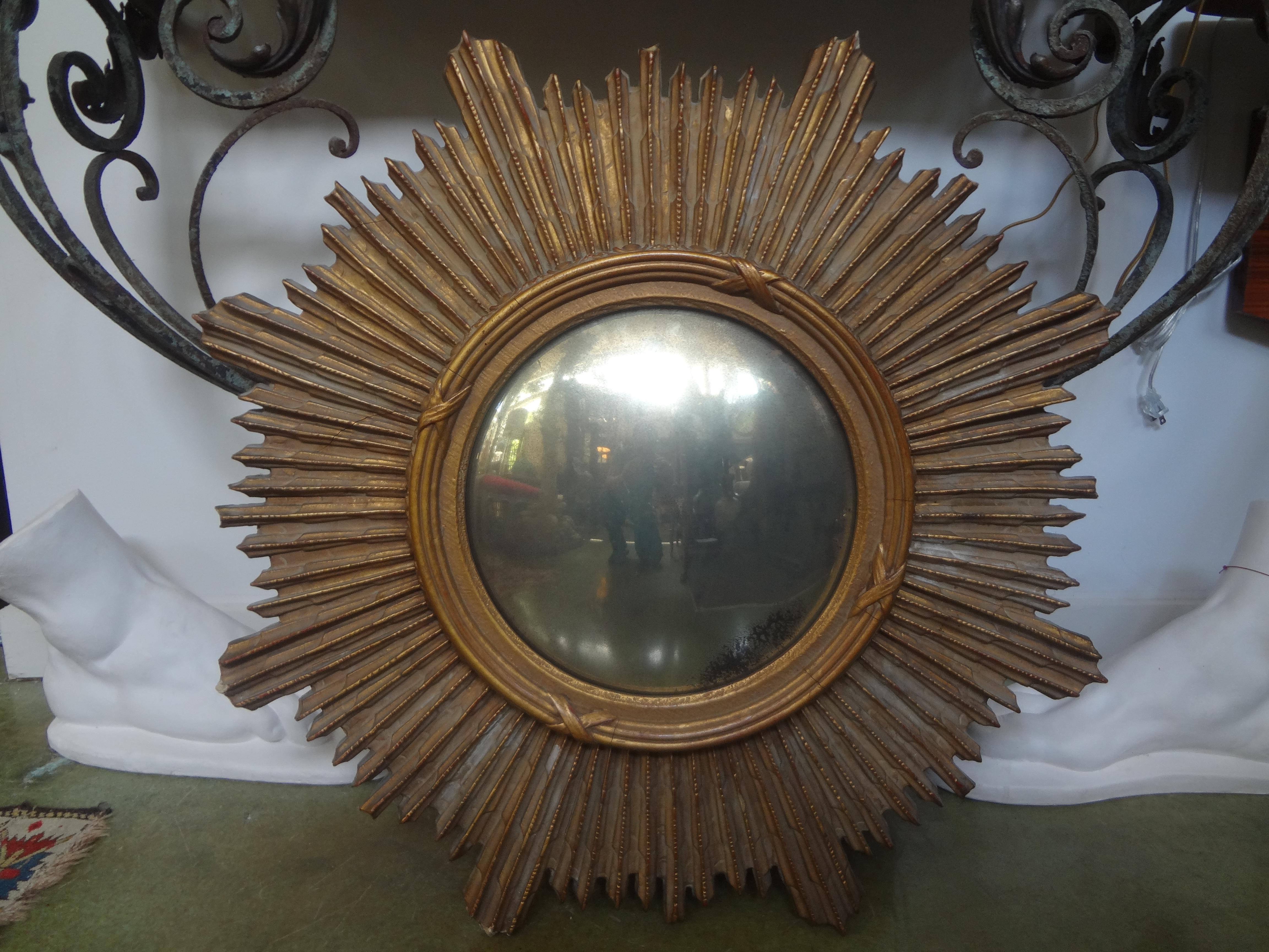 French giltwood sunburst convex mirror. This stunning French carved gilt wood sunburst mirror has a warm aged patina and good scale. Beautiful aged convex mirror.