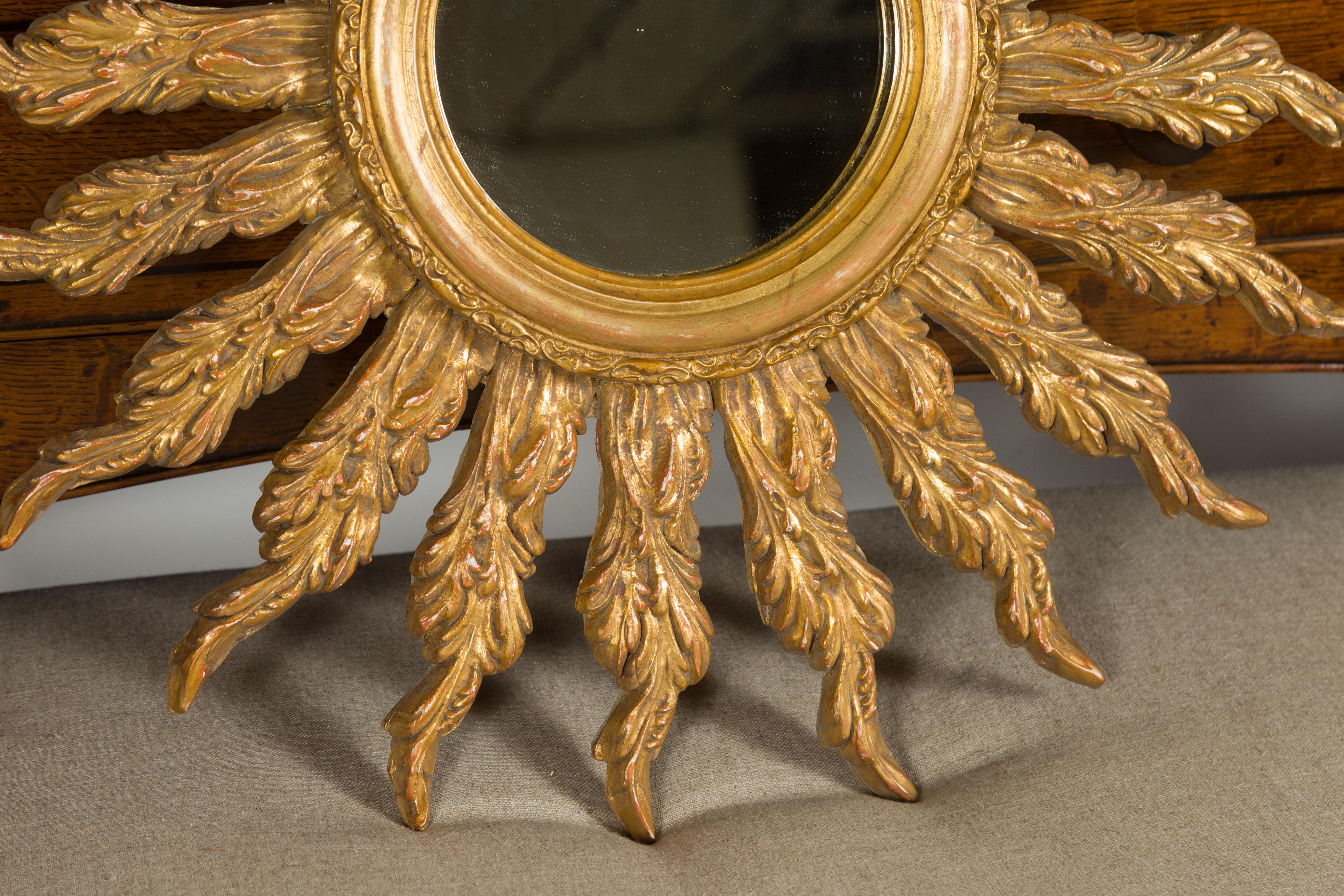 French Giltwood Sunburst Mirror with Wavy Sunrays from the Mid-20th Century In Good Condition For Sale In Atlanta, GA
