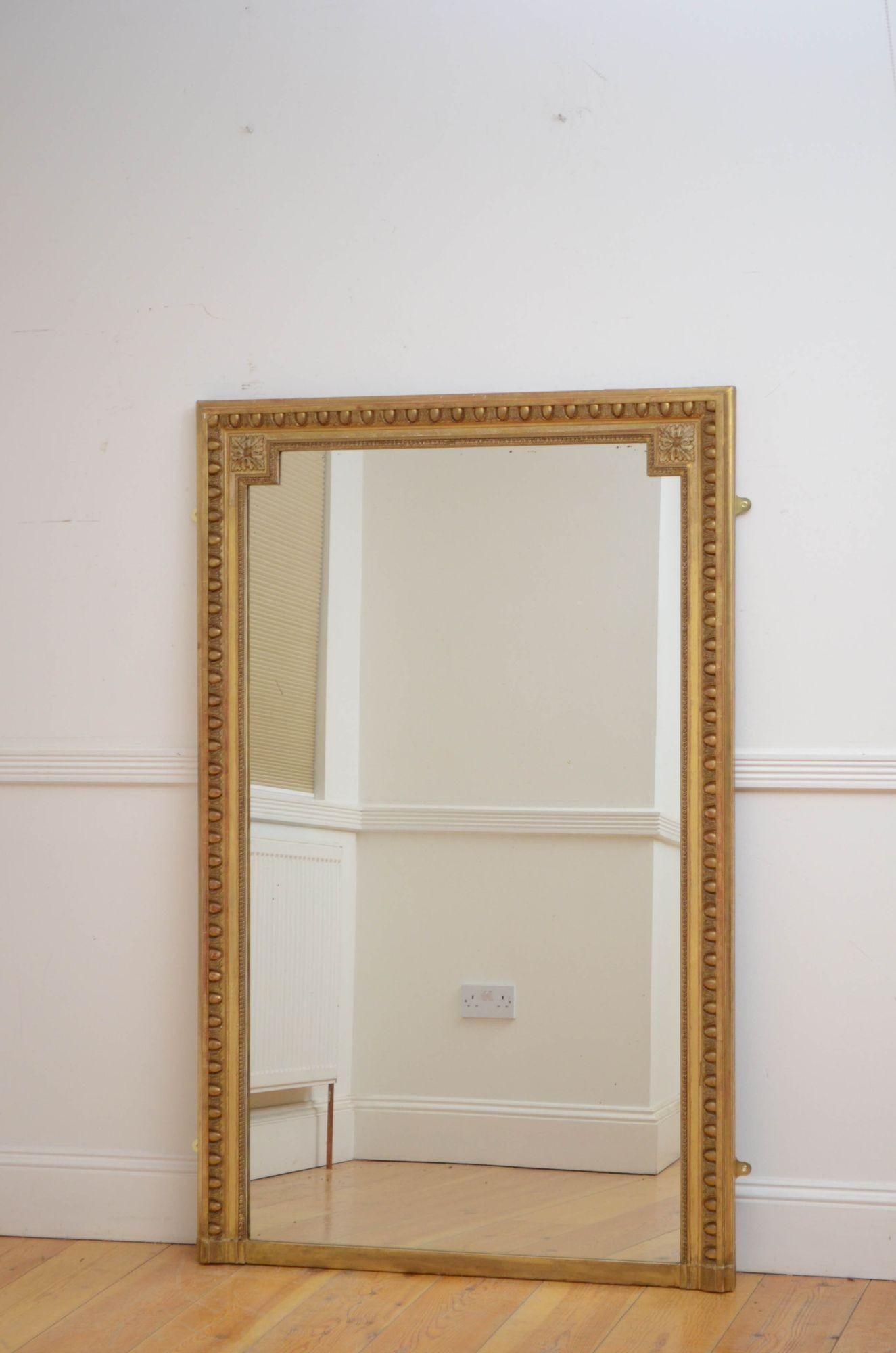 Sn5264 Simple and elegant 19th century gilded mirror, having original slightly foxed glass in egg and dart carved, moulded and gilded frame with acanthus leaf decorated top corners. This antique mirror retains its original gilt, glass and