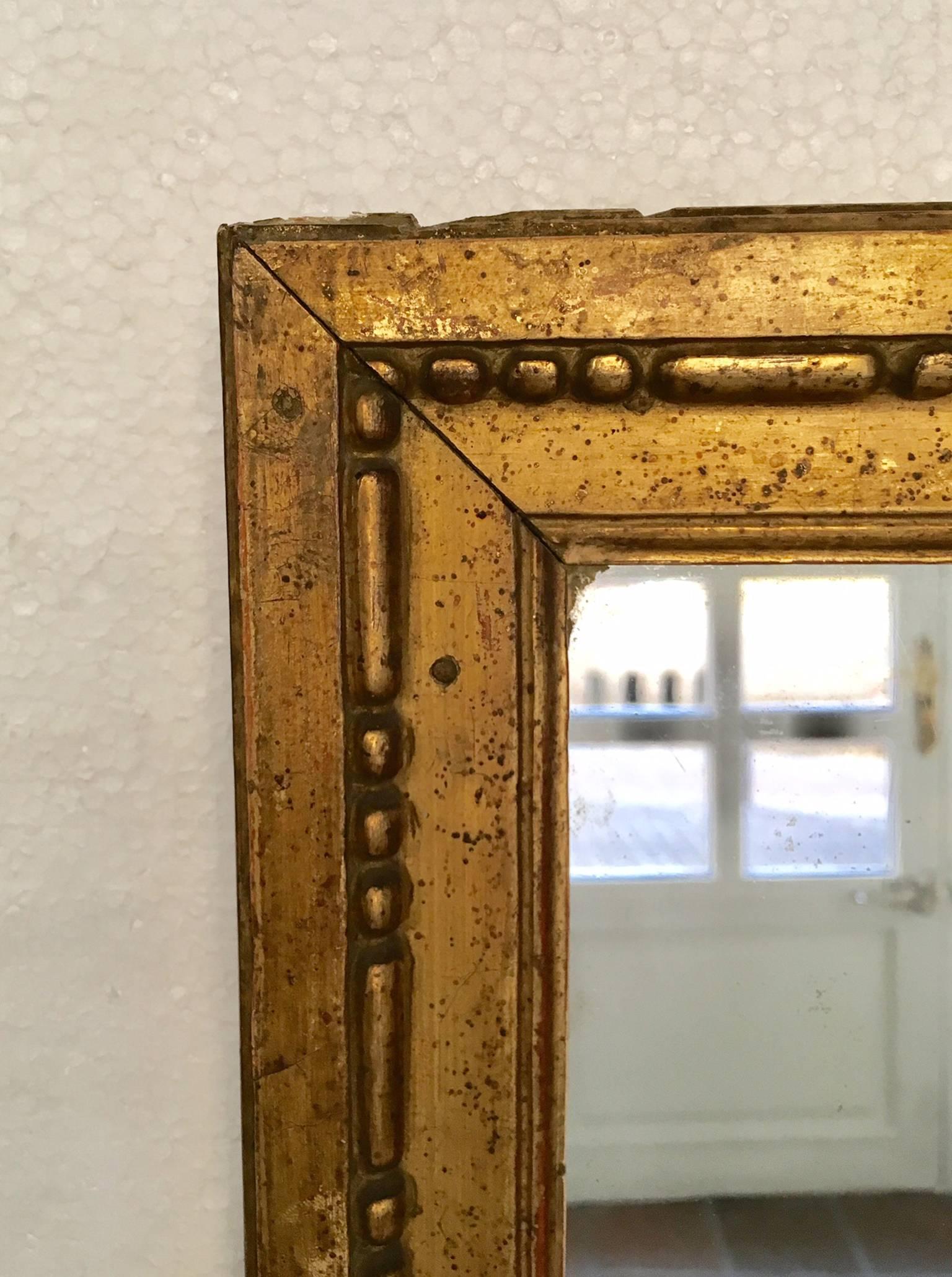 Louis XVI period giltwood mirror, two-part mercury plate. Is original, excellent condition and nice patina.