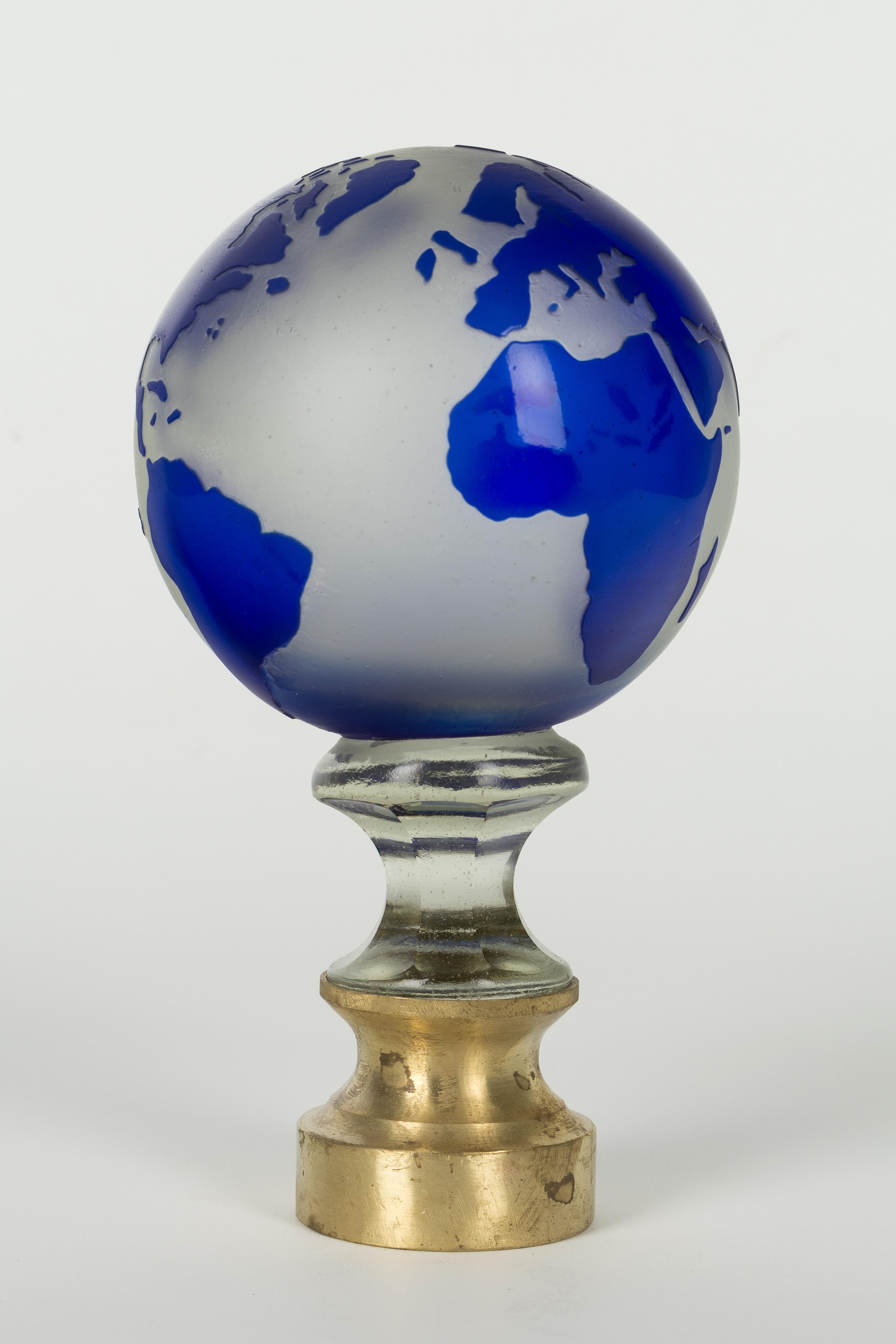 An early 20th century French glass globe newel post finial or boule d'escalier. These wonderful finials were used as decorative elements at the bottom of a staircase on the newel post. This one is made of two layers of cased glass with the cobalt
