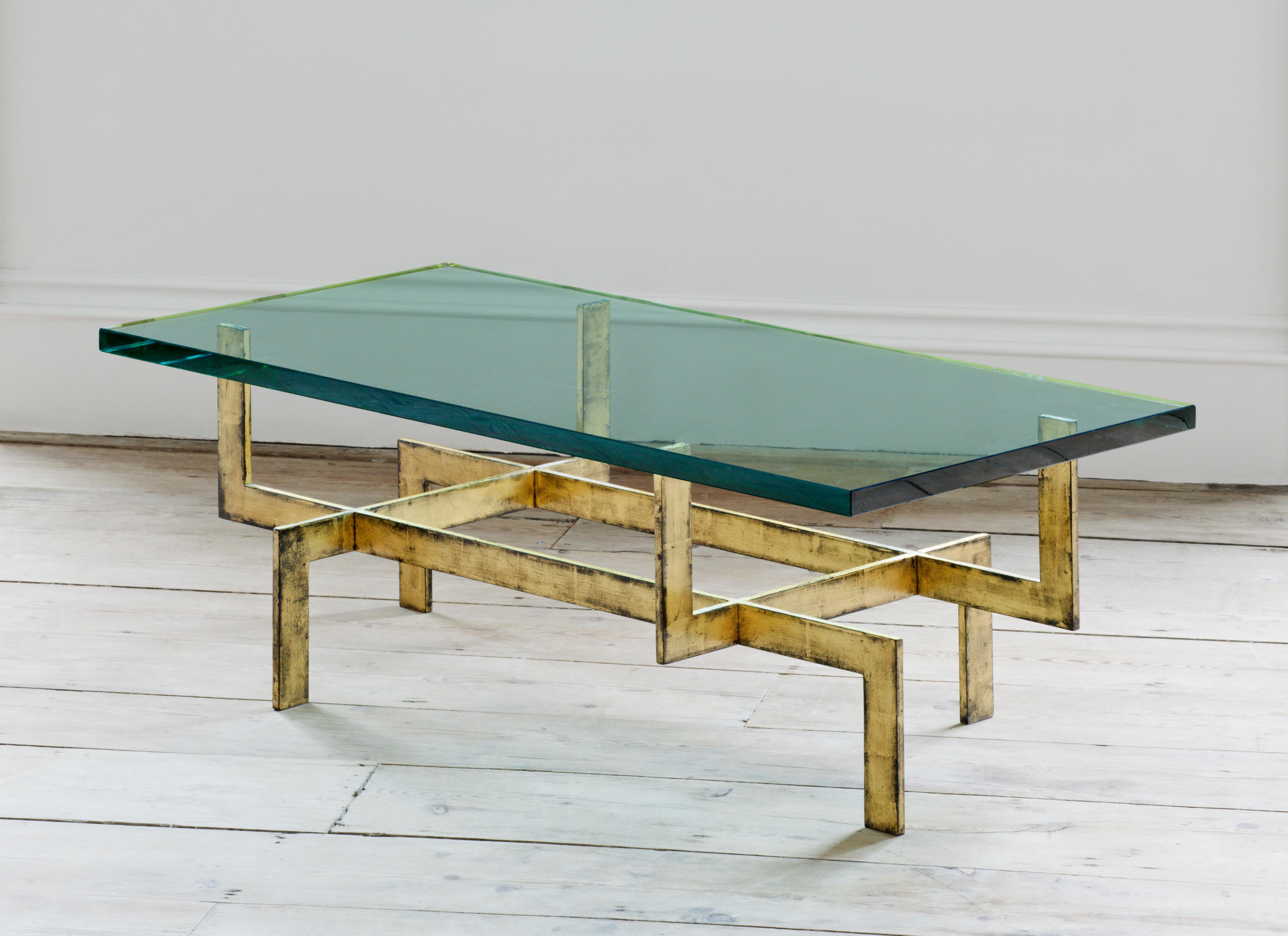 Made from gilt bronze and with a substantial glass top, this coffee table typifies the strident designs of the 1930s, the jazz age of the inter war years and the revolutionary designs that were first shown at L’Exposition Internationale des Arts