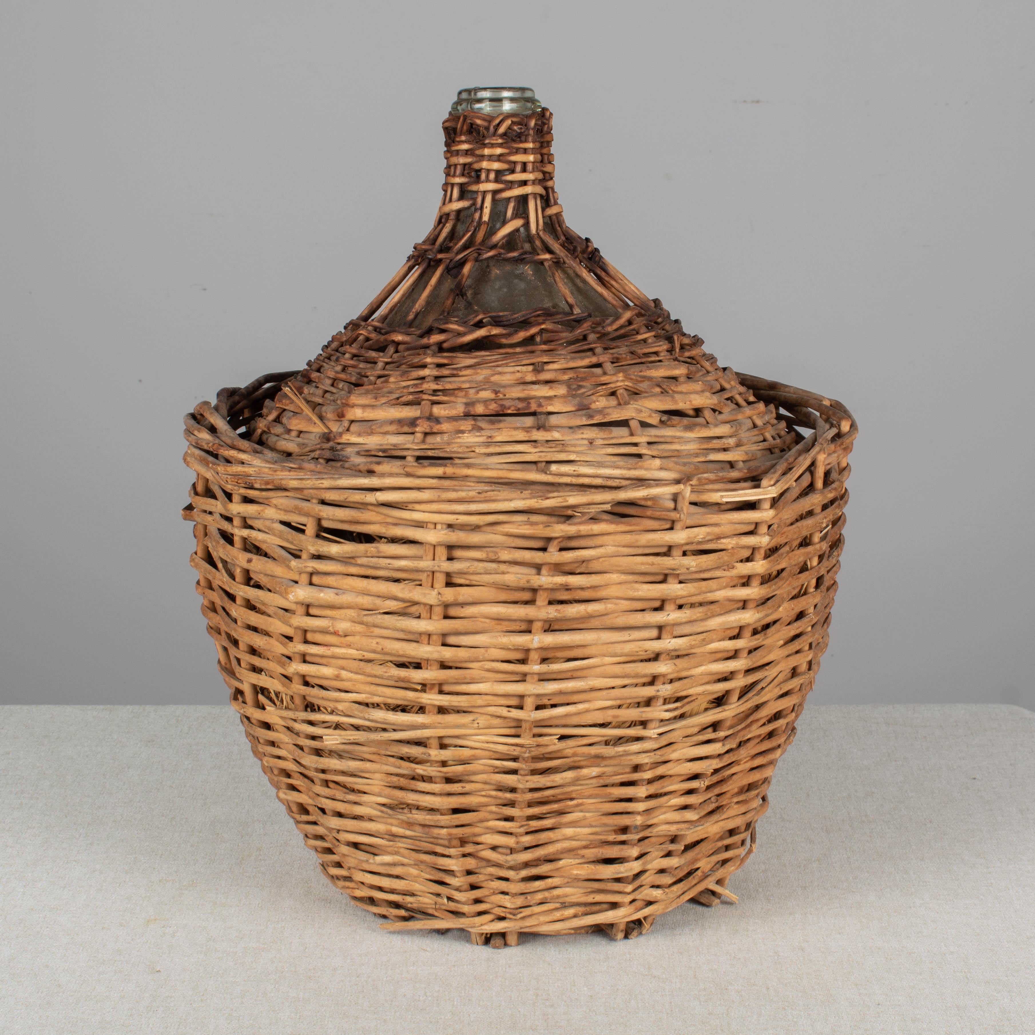 Country French Glass Demijohn Bottle in Woven Basket