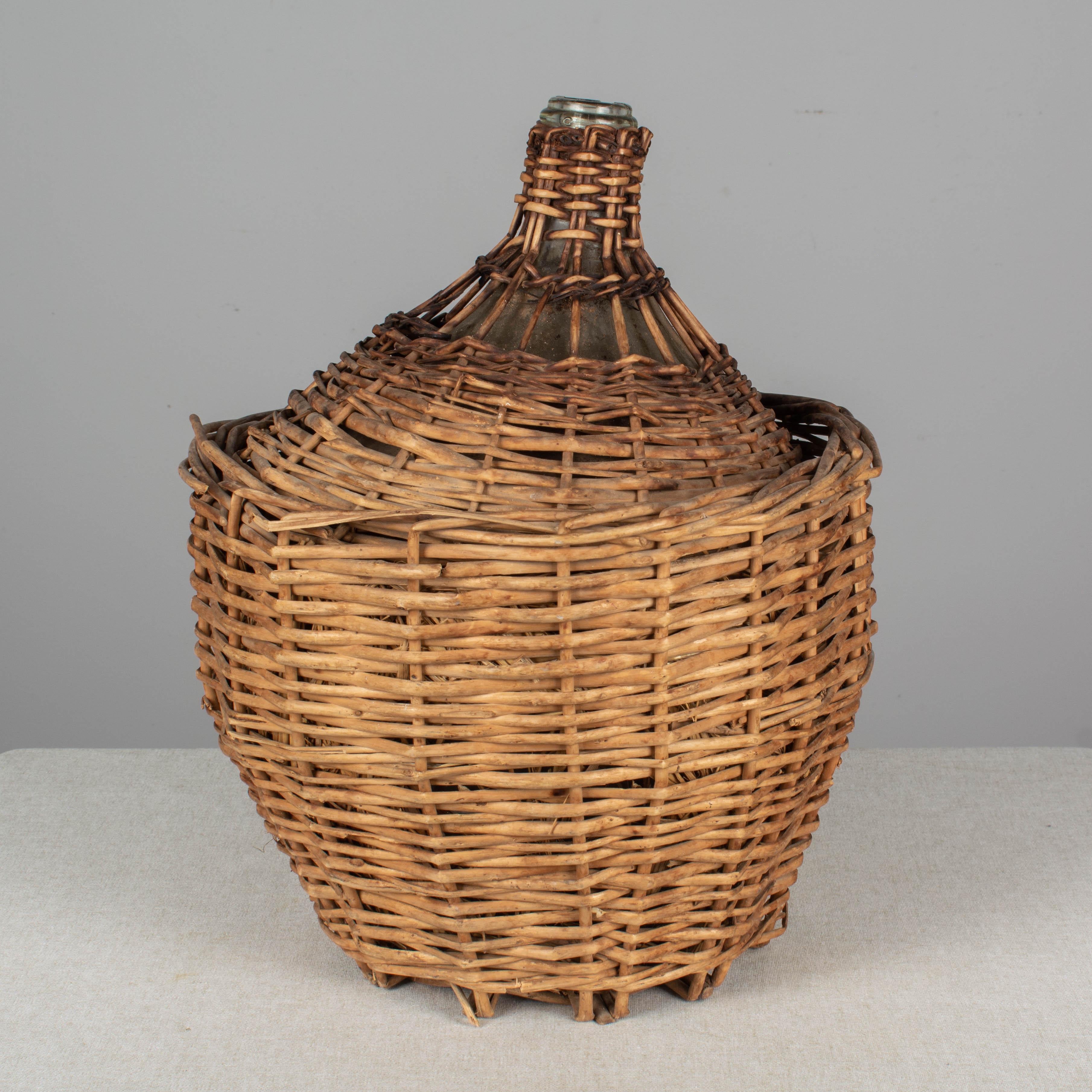 Hand-Crafted French Glass Demijohn Bottle in Woven Basket