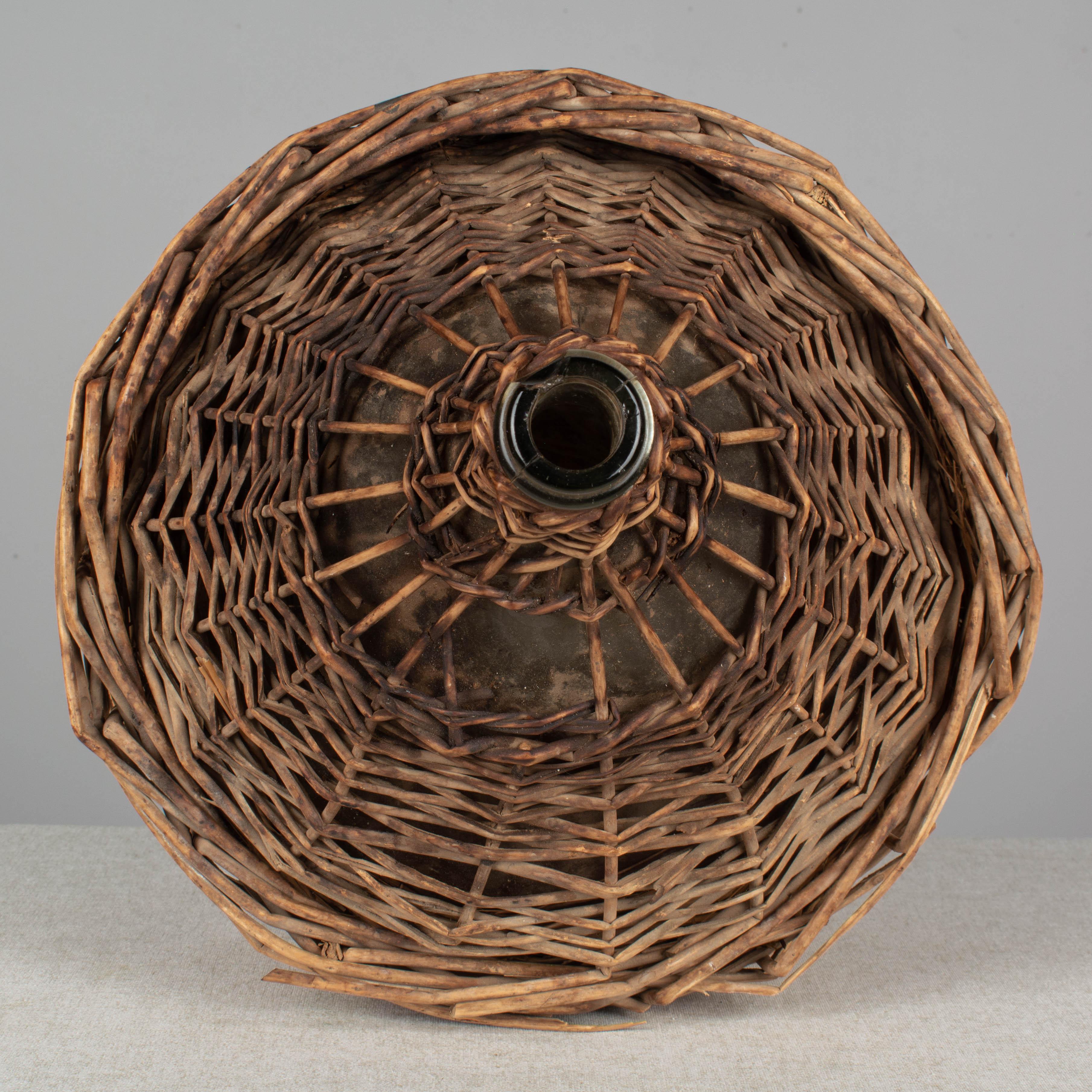 20th Century French Glass Demijohn Bottle in Woven Basket