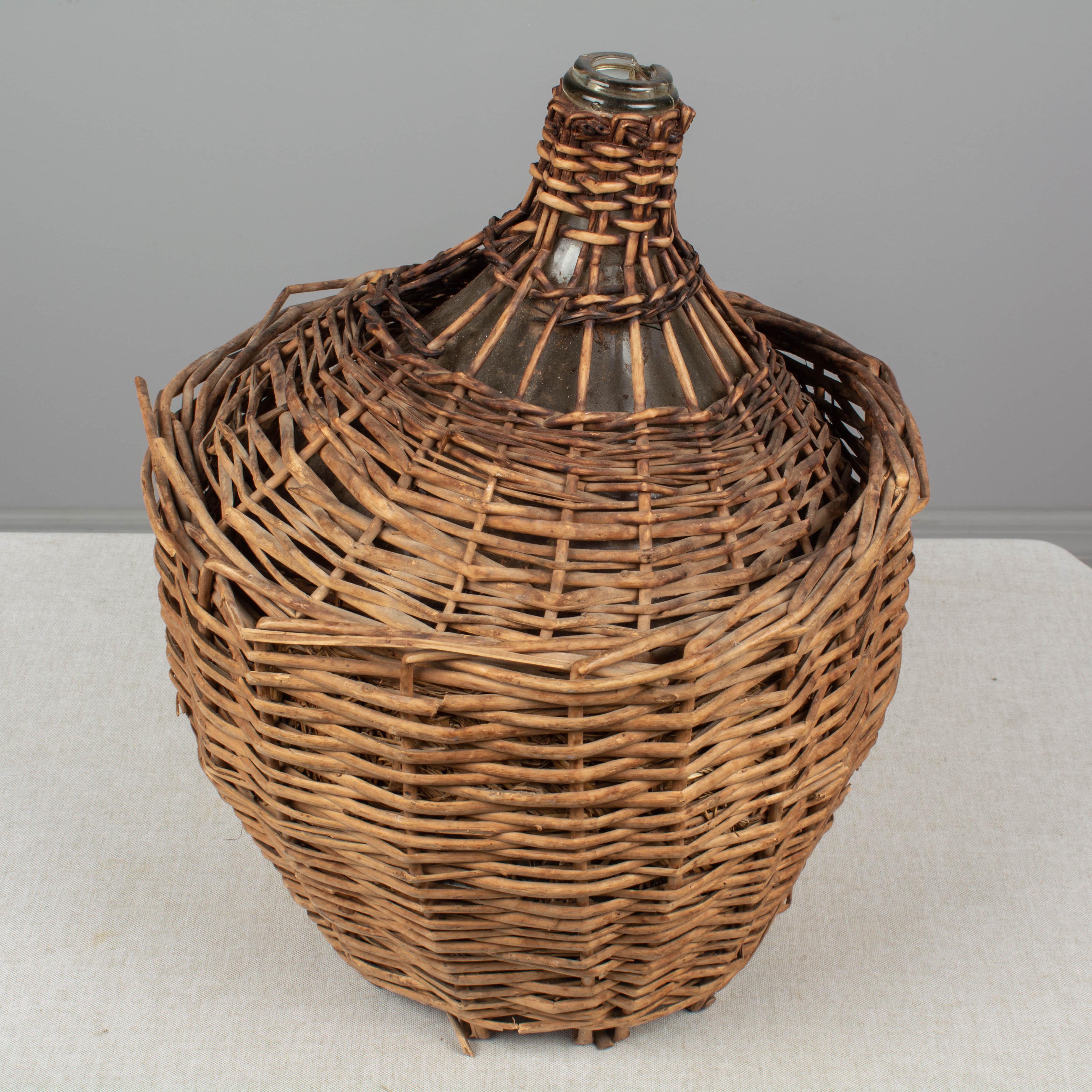 French Glass Demijohn Bottle in Woven Basket 1
