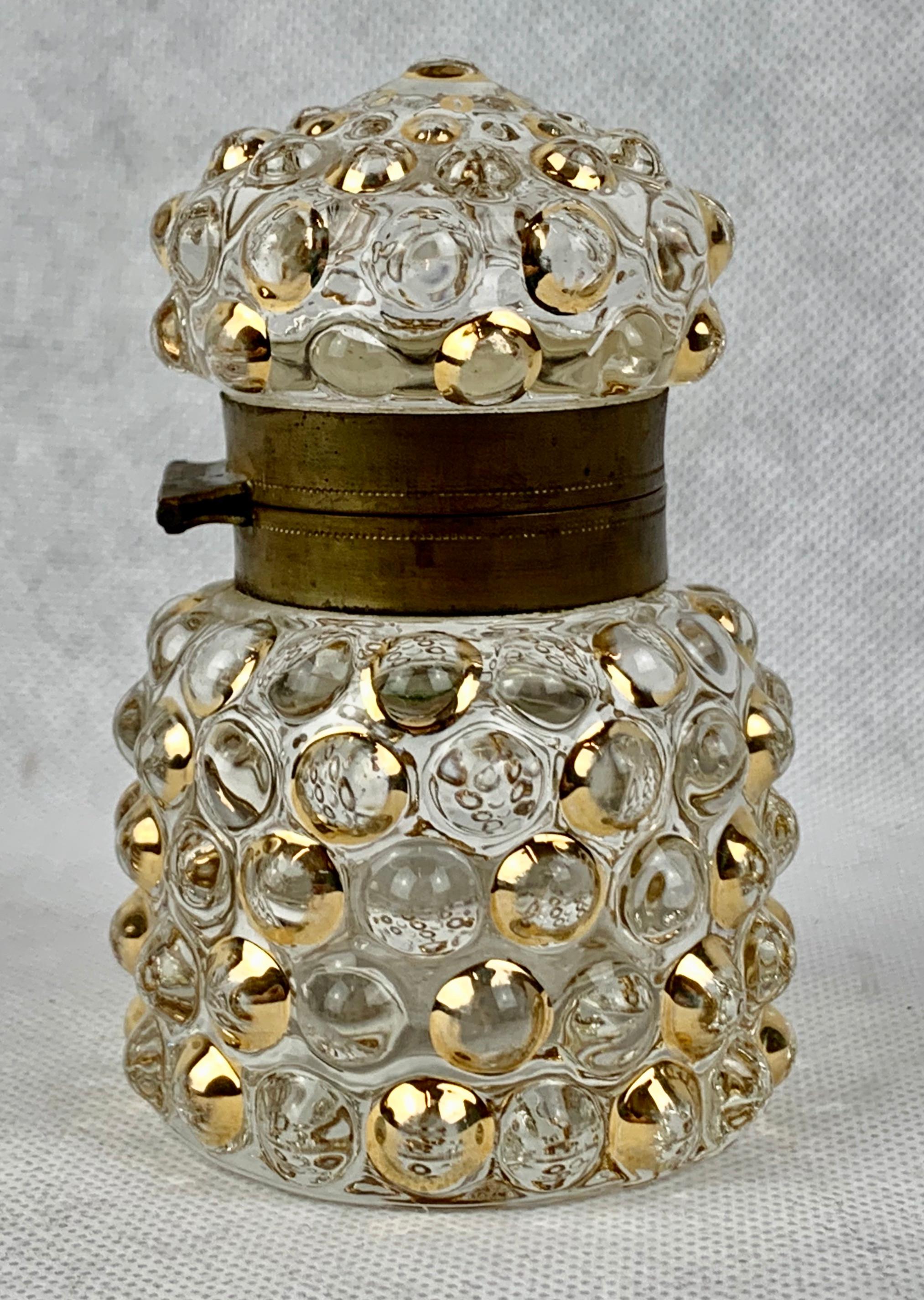 French 19th century glass inkwell. The design is one of diagonal bubbles with every other one gilt. The collar is brass. I left the collar with its natural darkened patina.