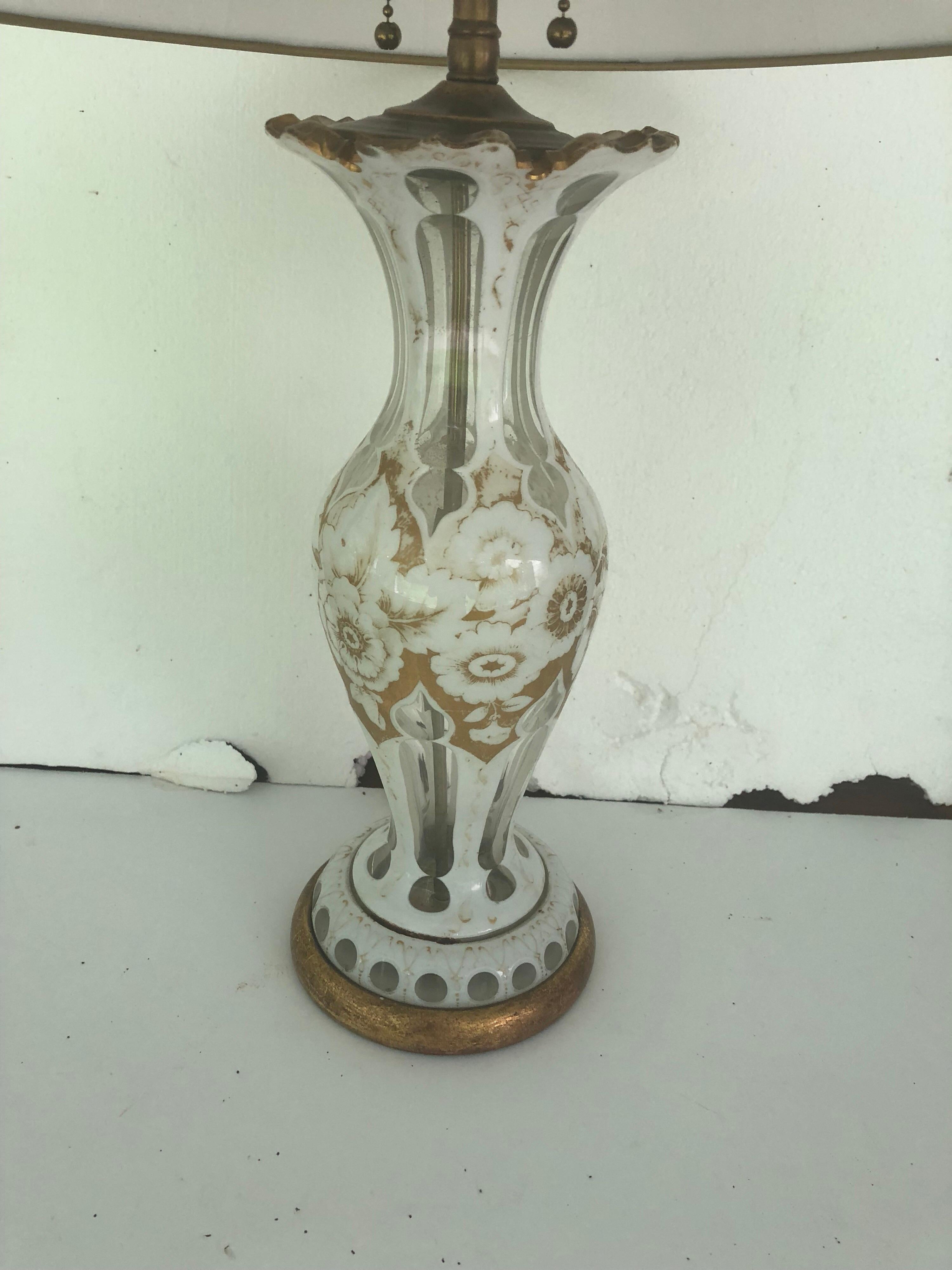French glass lamp with gold and white floral decorations, on a gilded wooden base. Recently rewired. Shade not included. Height 24