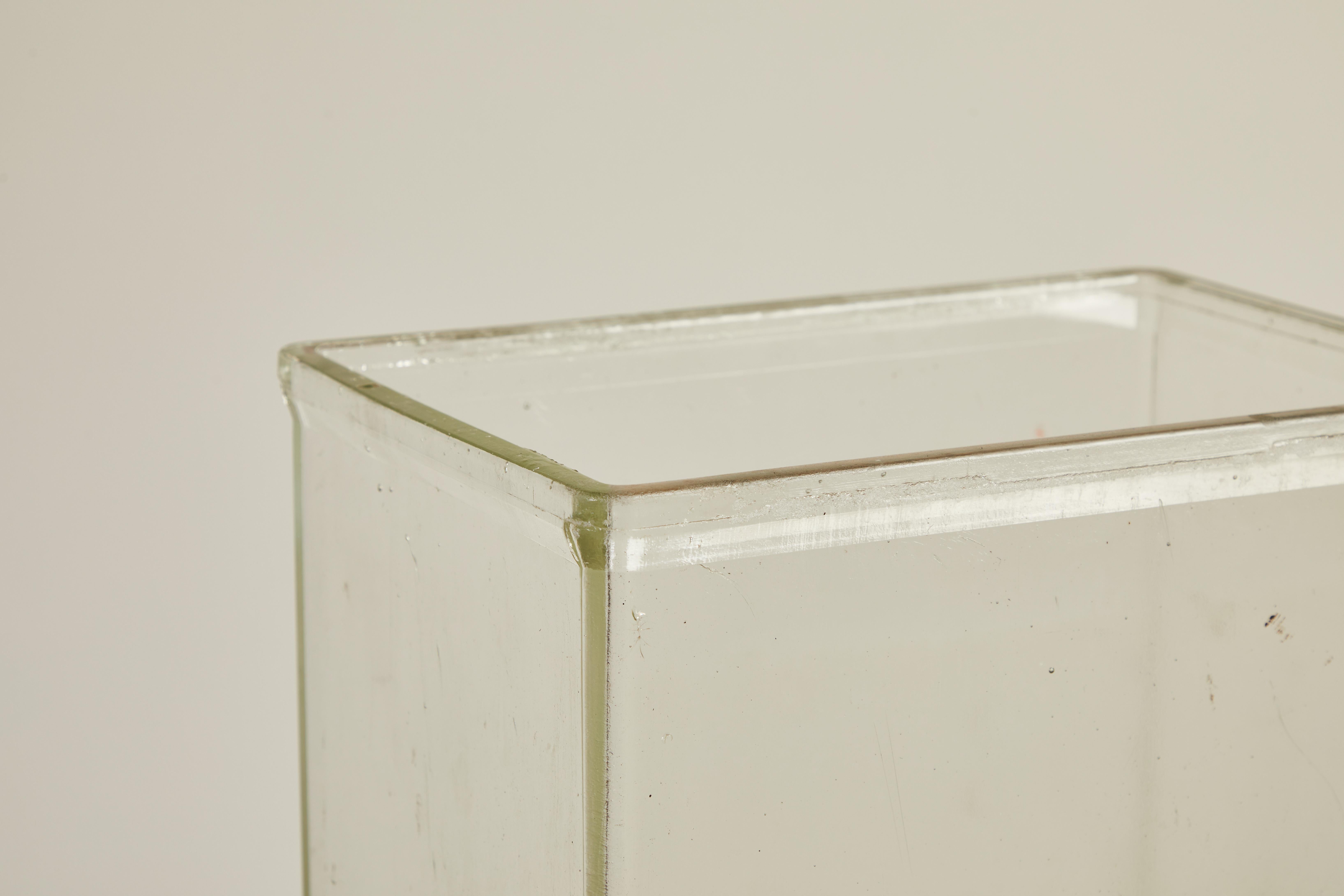 French glass tall rectangular vase, with a slightly curved lip. The glass is thick and sturdy.