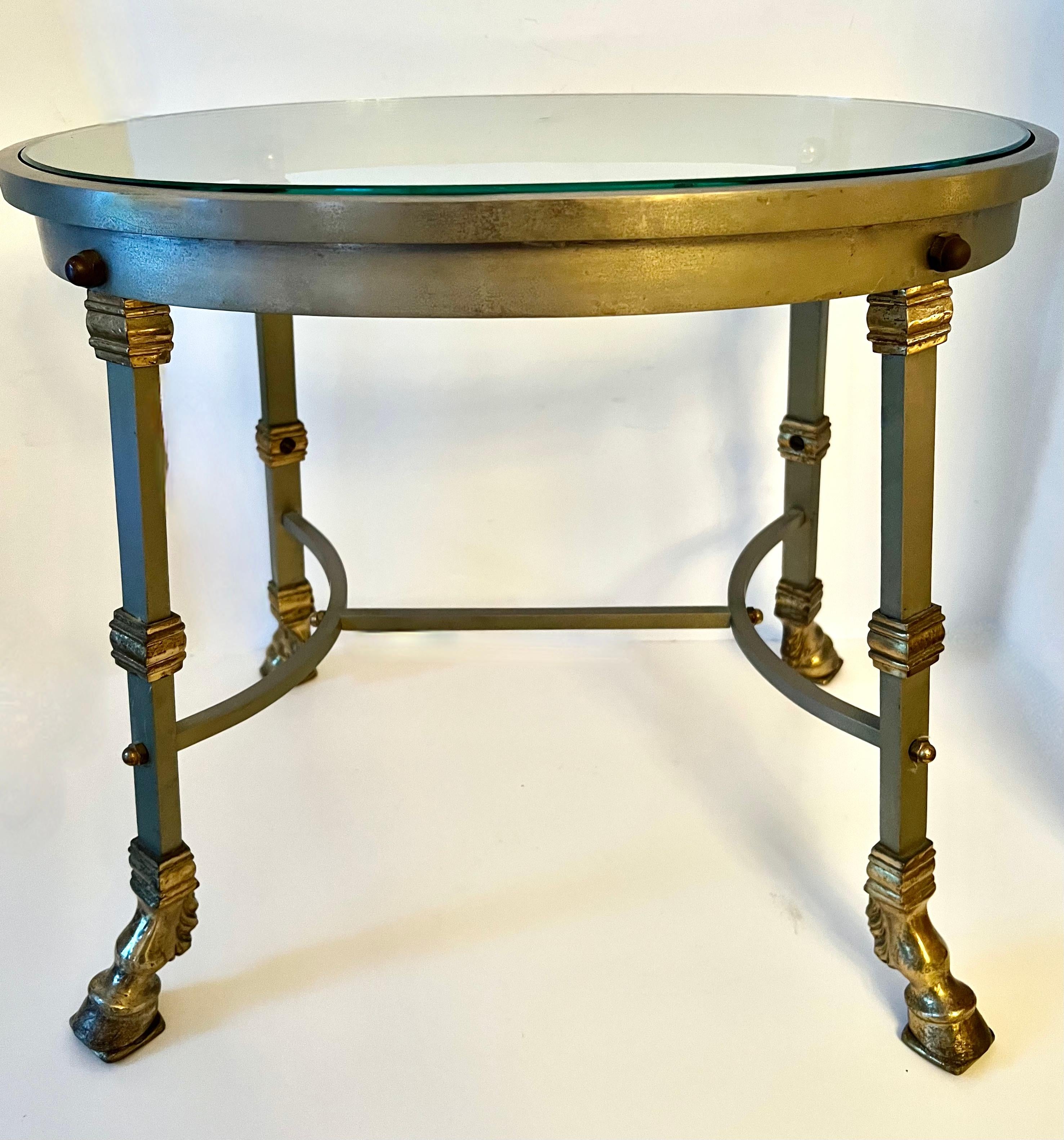 Maison Jansen Steel, brass and bronze glass top table.  This table is so good!   The design is thoughtful and architectural - a handsome addition to any space.  the brass fittings and bronze hoof feet are truly spectacular.

A beautifully decorative