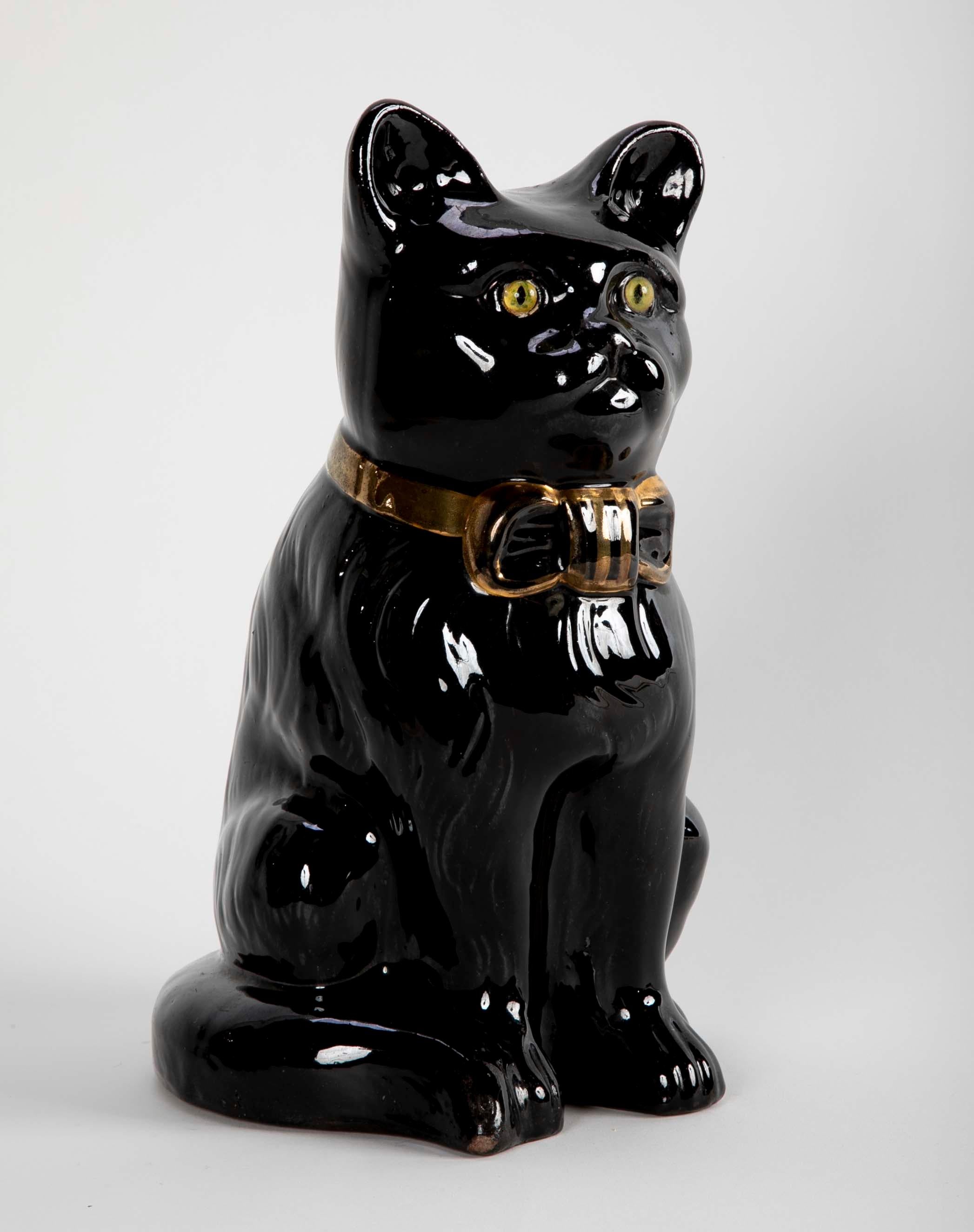 A charming seated glazed ceramic black cat with yellow glass eyes and gilt bow around neck. What I find most appealing about this feline is the rather serious look on her face. French, circa 1950's
Measures: 12 inches high 8 wide 7 deep.