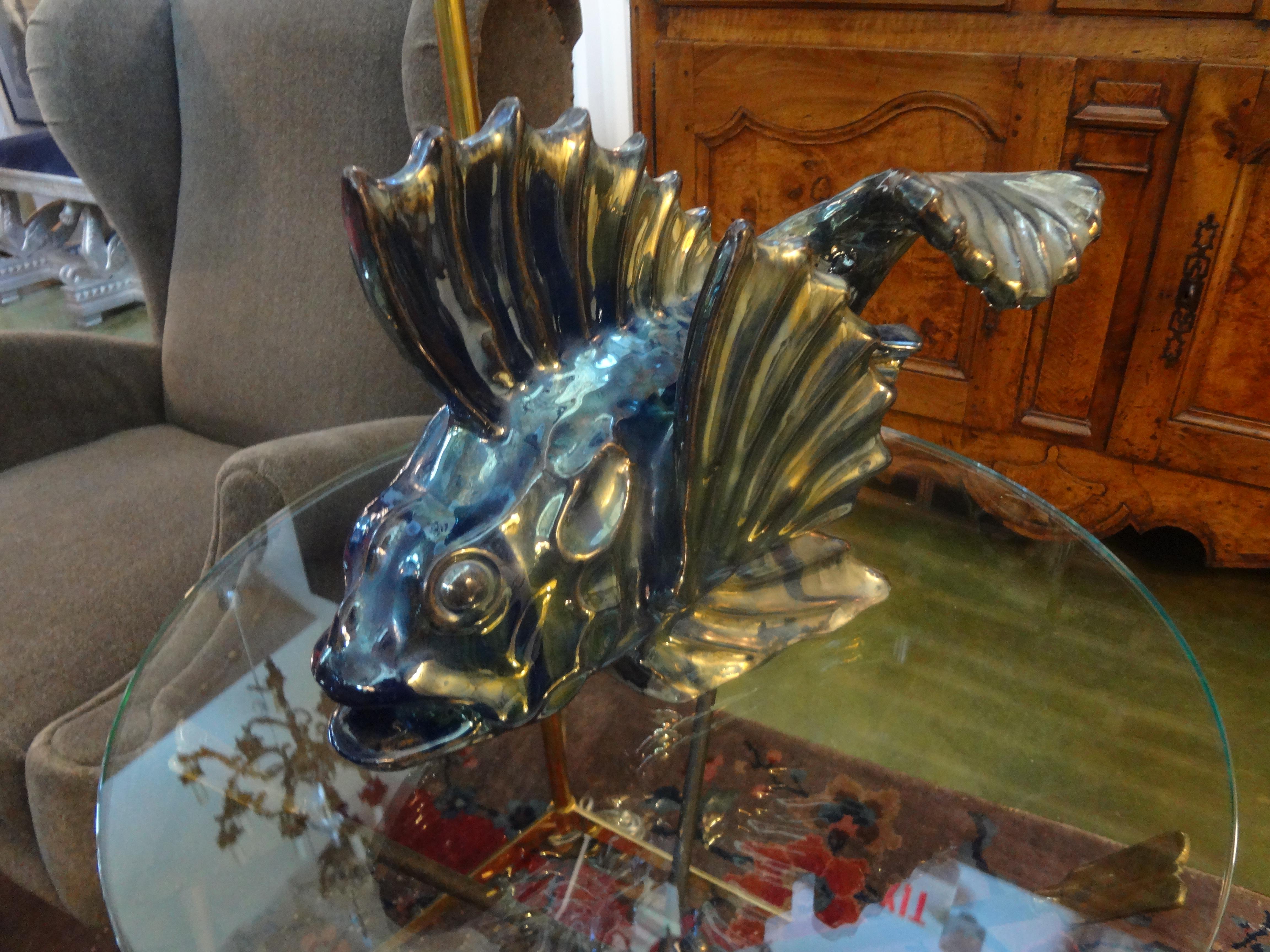 Interesting antique French iridescent glazed terracotta fish sculpture. This French fish figure is executed in iridescent tones of blue and green with beautiful movement. This French Art Deco stylized fish dates to the 1920s. The glaze is similar to
