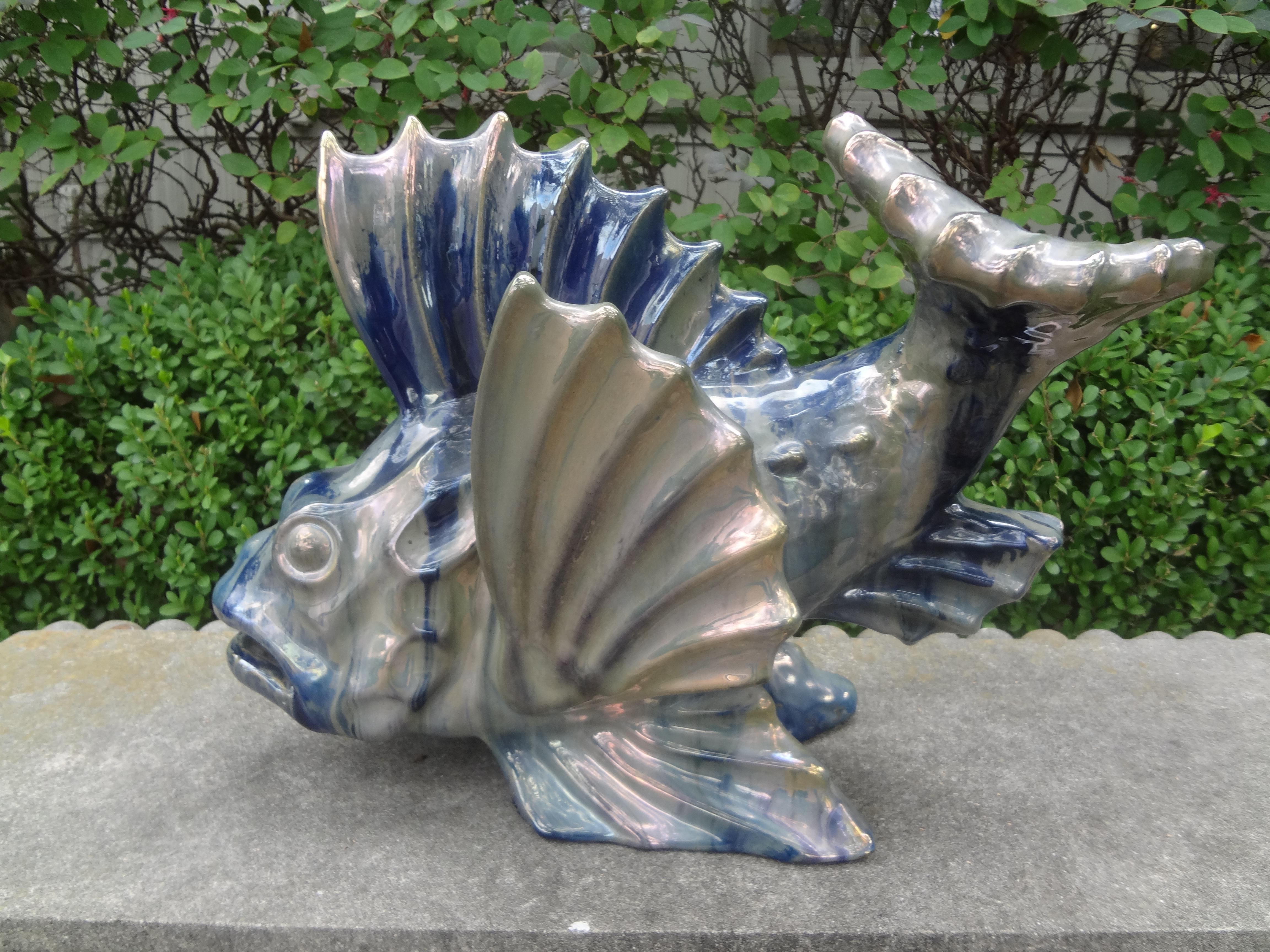 French Glazed Terracotta fish sculpture.
Interesting antique French iridescent glazed terracotta fish sculpture. This French fish figure is executed in iridescent tones of blue and green with beautiful movement. This French Art Deco stylized fish