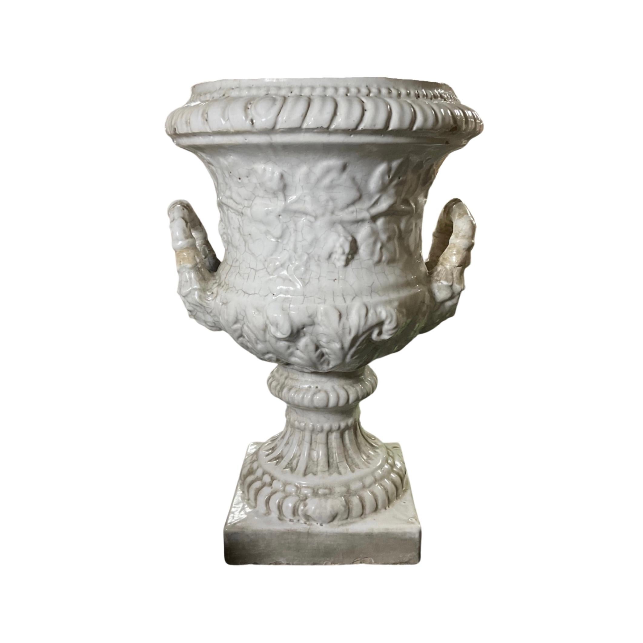 Handcrafted from terracotta in France, this 19th century glazed planter will add timeless charm to your garden. Its white glaze and antique design make it the perfect accent to any outdoor space. Planter features 2 side handles.