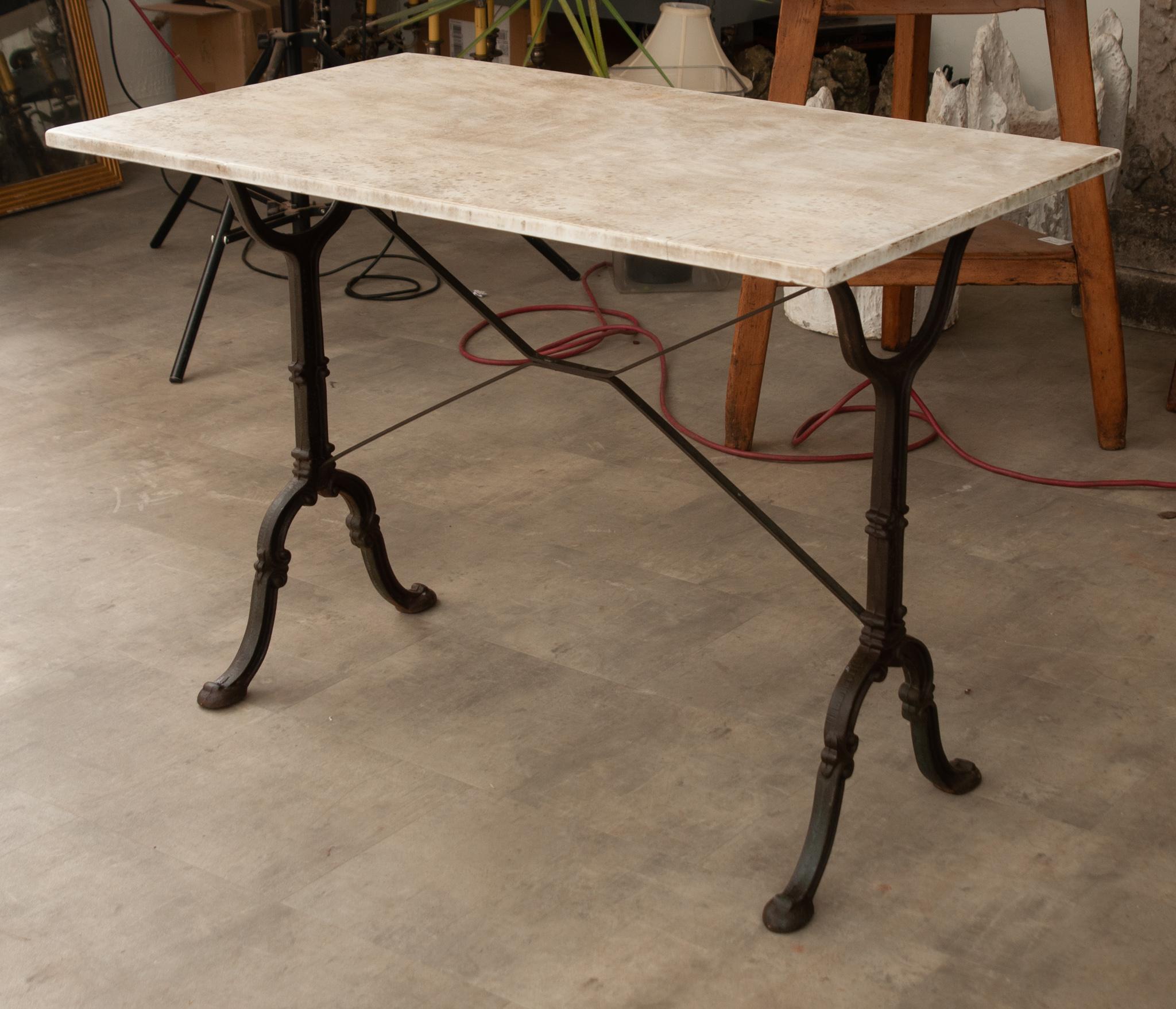 A wonderful French marble-top bistro table dated circa 1880 with a classically styled painted iron base that includes the mark of its maker, Godin, on the legs. The marble top has beautiful veining and inclusions throughout. The base has X-form