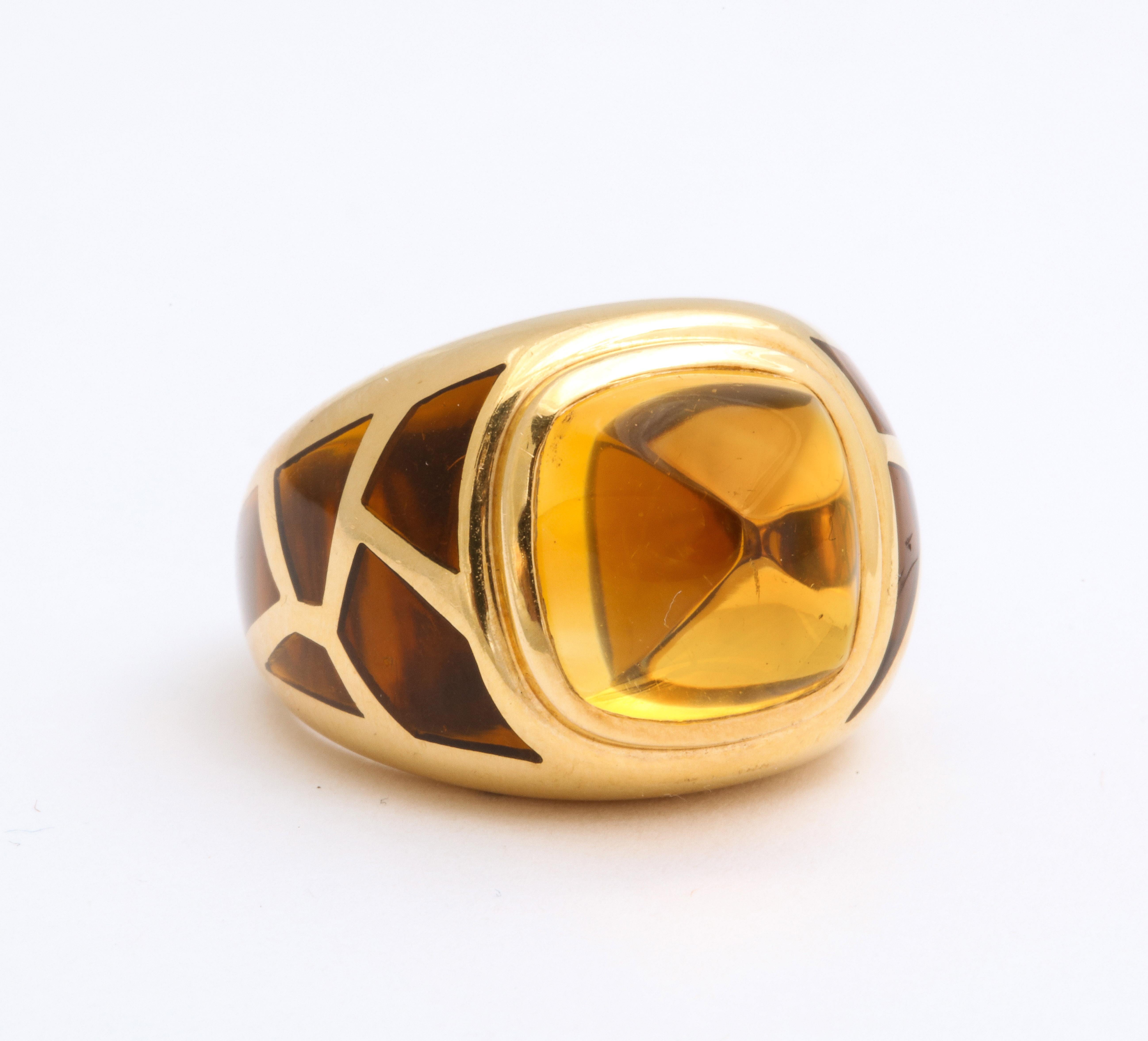 An exqusite  French dome ring with a sugarloaf citrine set in a 18 kt gold and  invisibly set panels of stones near a mosaic pattern with Boivin maker mark.